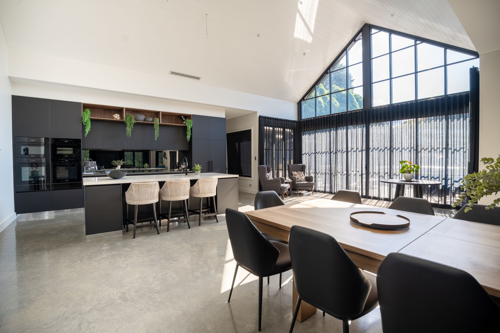 Modern Dining Room With Black Chairs and Large Floor-to-ceiling Windows — Matt Made Building in Camden, NSW