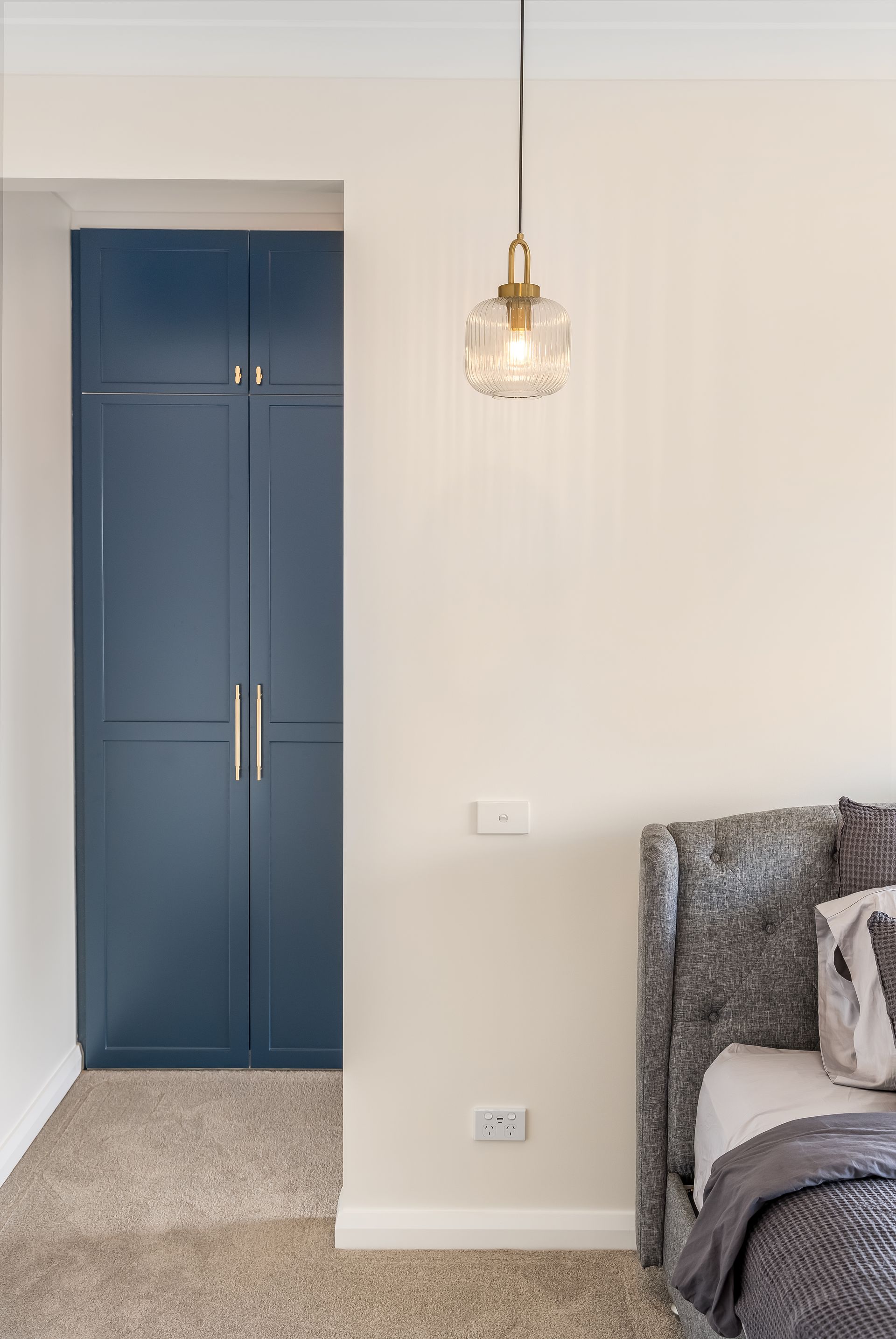 Bedroom Corner With Navy Wardrobe and Part of a Bed on the Right — Matt Made Building in Camden, NSW