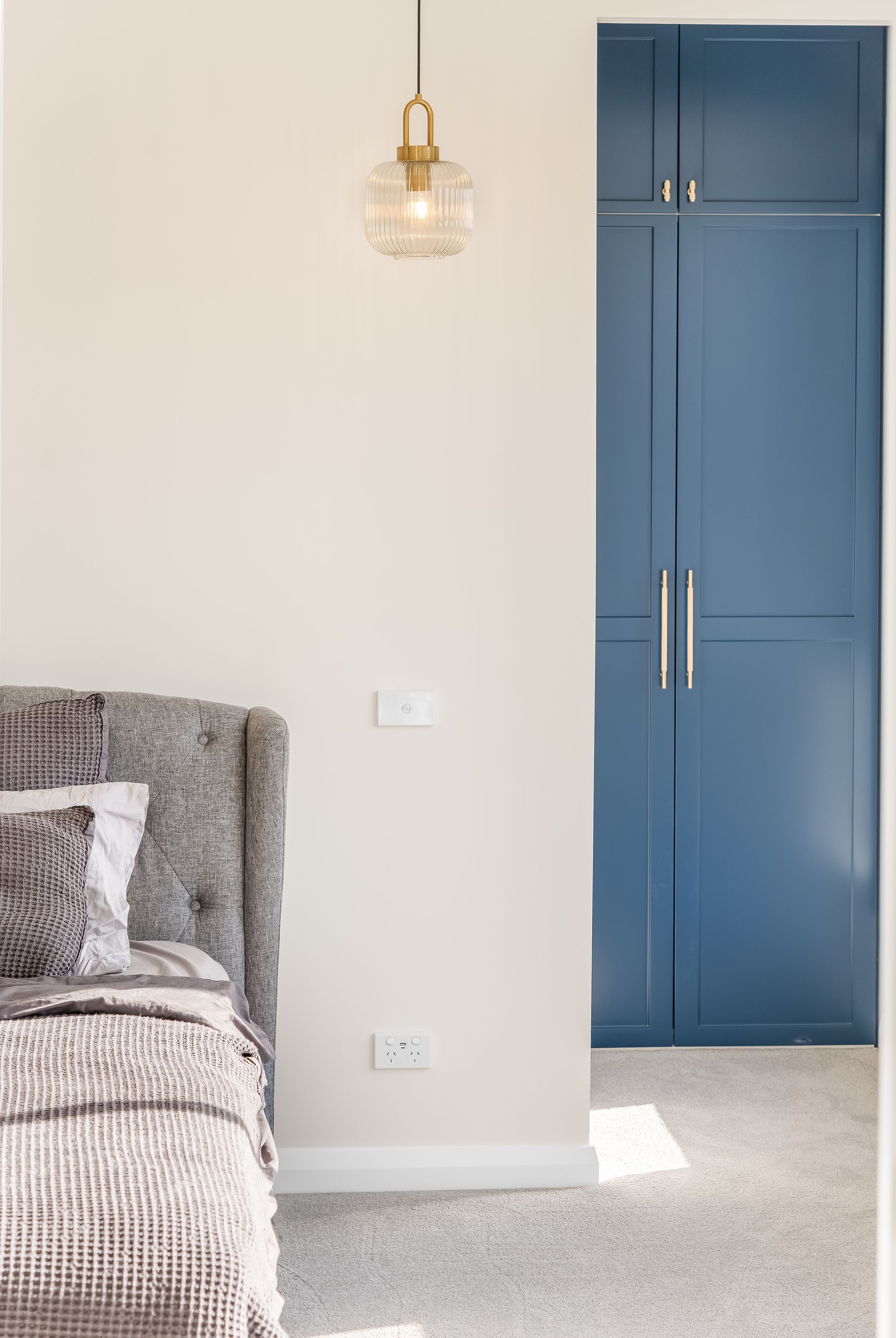 Bedroom With a Blue Built-in Wardrobe and Part of a Bed Visible on the Left — Matt Made Building in Camden, NSW
