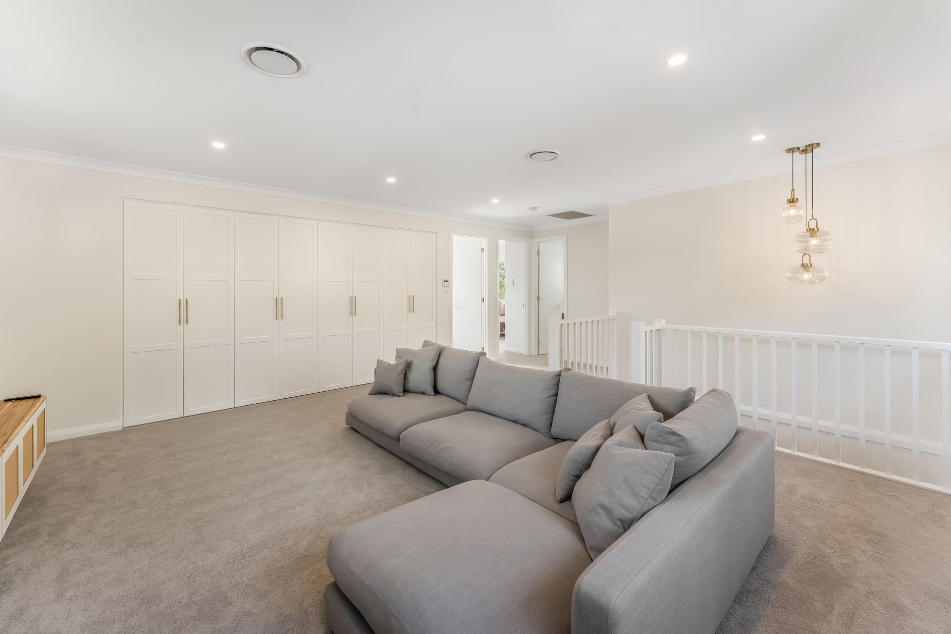 Bright Modern Living Room With Gray Sectional Sofa and Built-in Cabinets — Matt Made Building in Camden, NSW