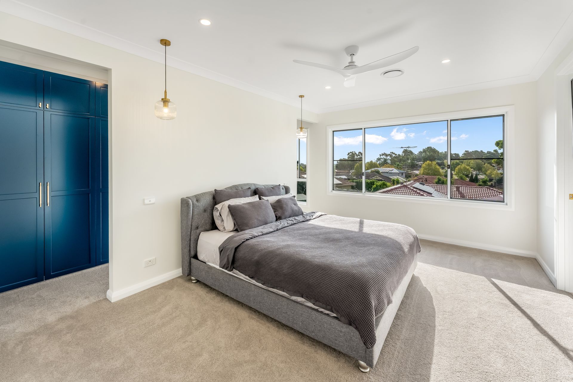 Bright Modern Bedroom With Gray Bedspread and a Large Window View — Matt Made Building in Camden, NSW