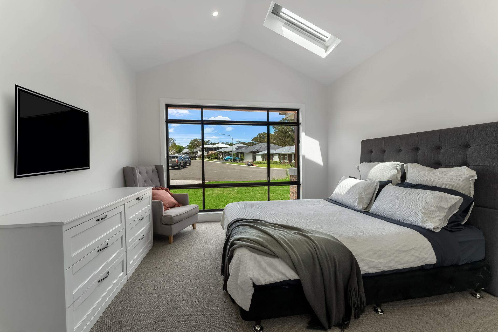 Modern Bedroom With Gray Bed and Sliding Doors to a Backyard View — Matt Made Building in Camden, NSW