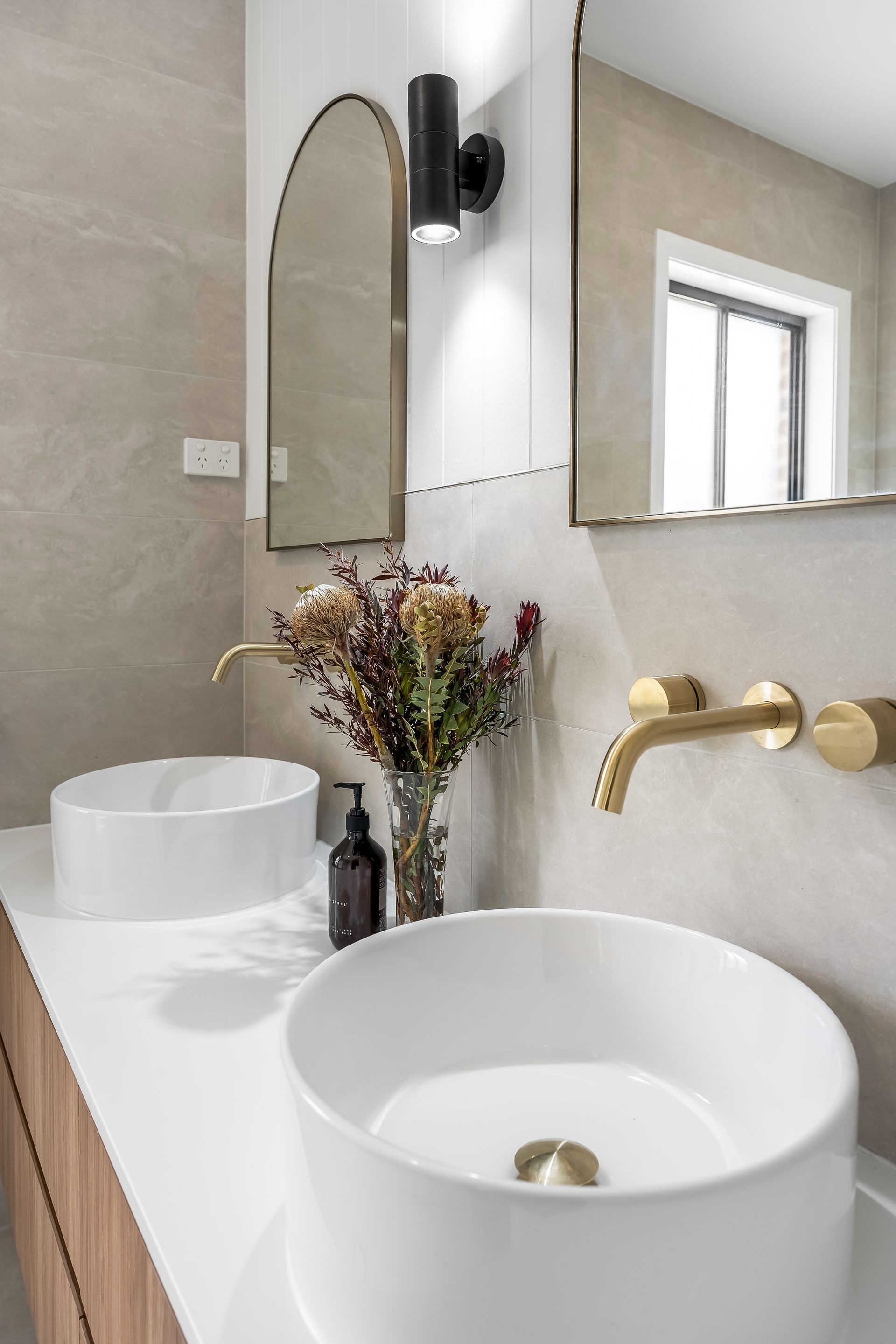 Modern Bathroom With Two White Vessel Sinks and Dried Flowers — Matt Made Building in Camden, NSW