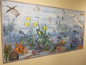 Underwater mural with sea turtles, fish, coral, and colorful marine plants