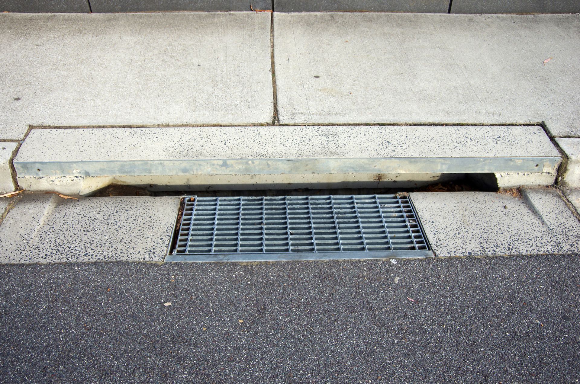A metal grate on the side of a road