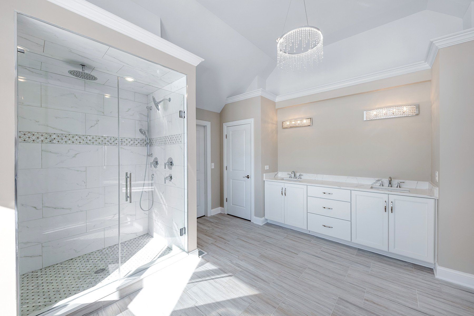 A bathroom with a walk in shower and a sink.