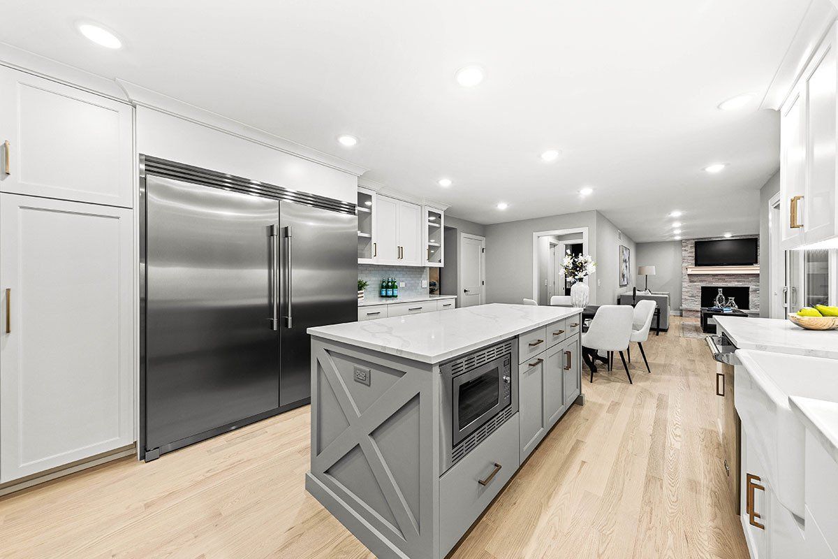 A kitchen with a large island and stainless steel appliances.