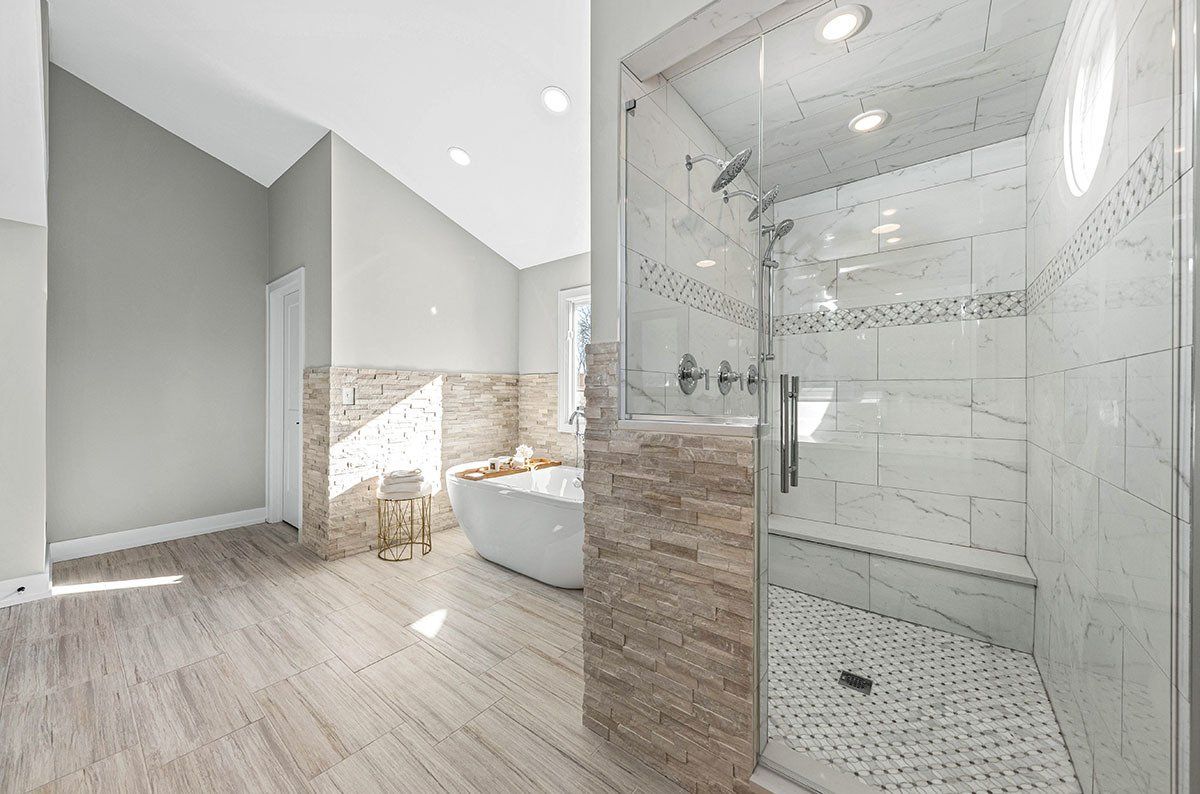 A bathroom with a walk in shower and a bathtub.