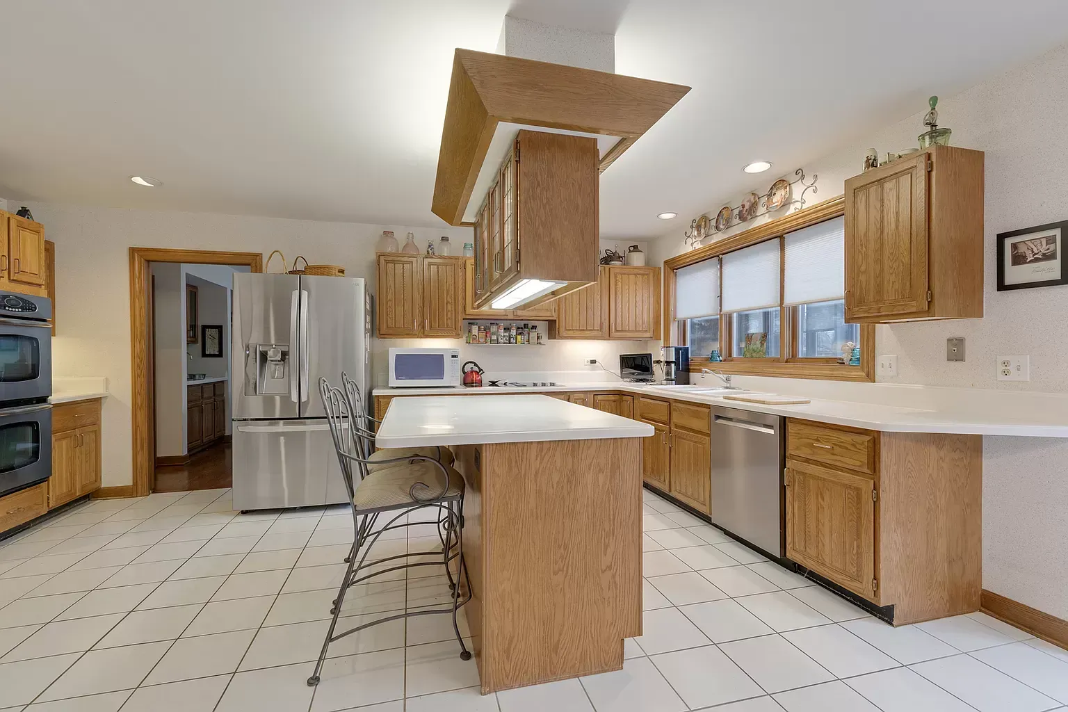 A kitchen with stainless steel appliances and wooden cabinets