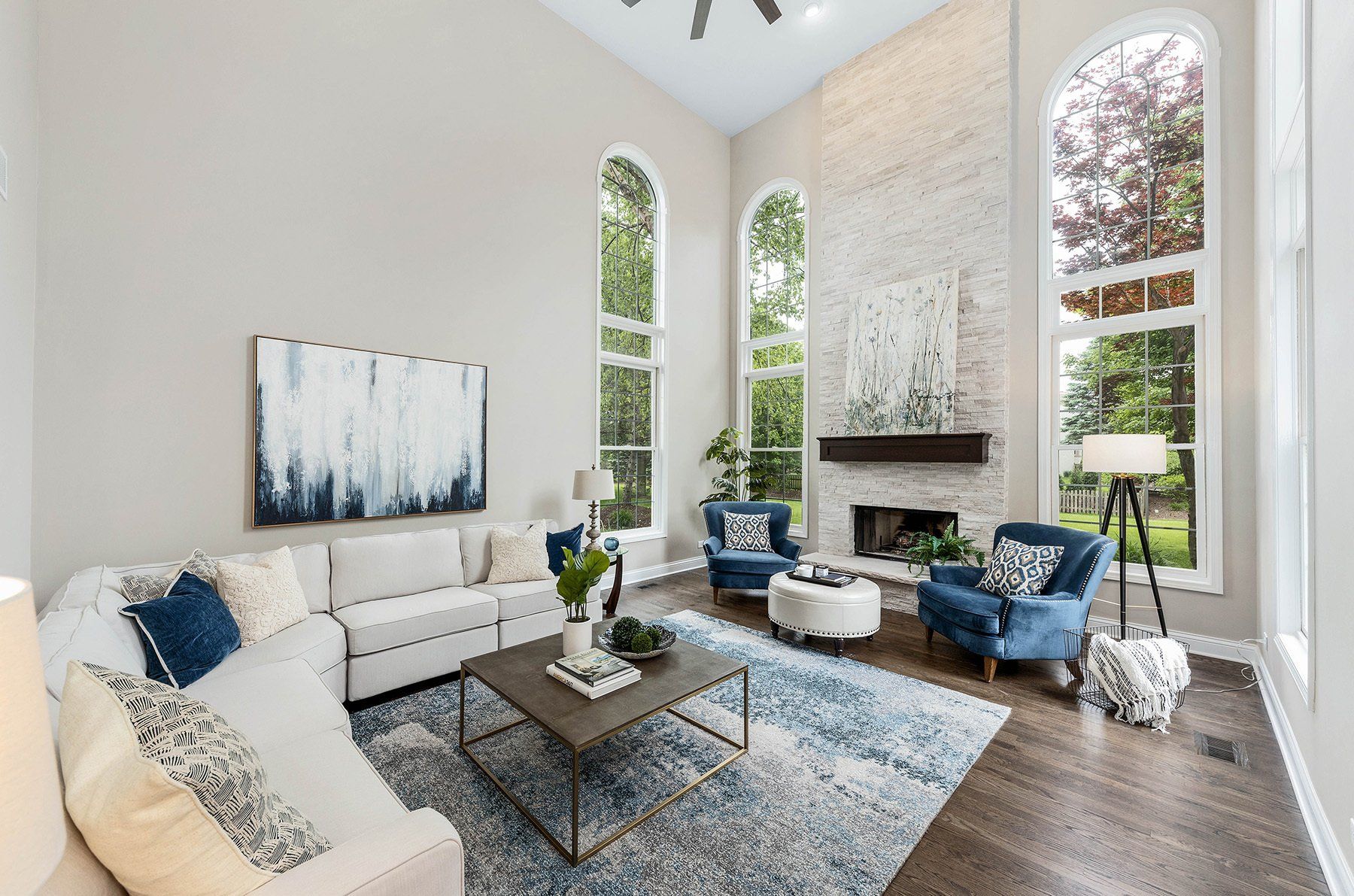 A living room with a couch , chairs , coffee table and fireplace.