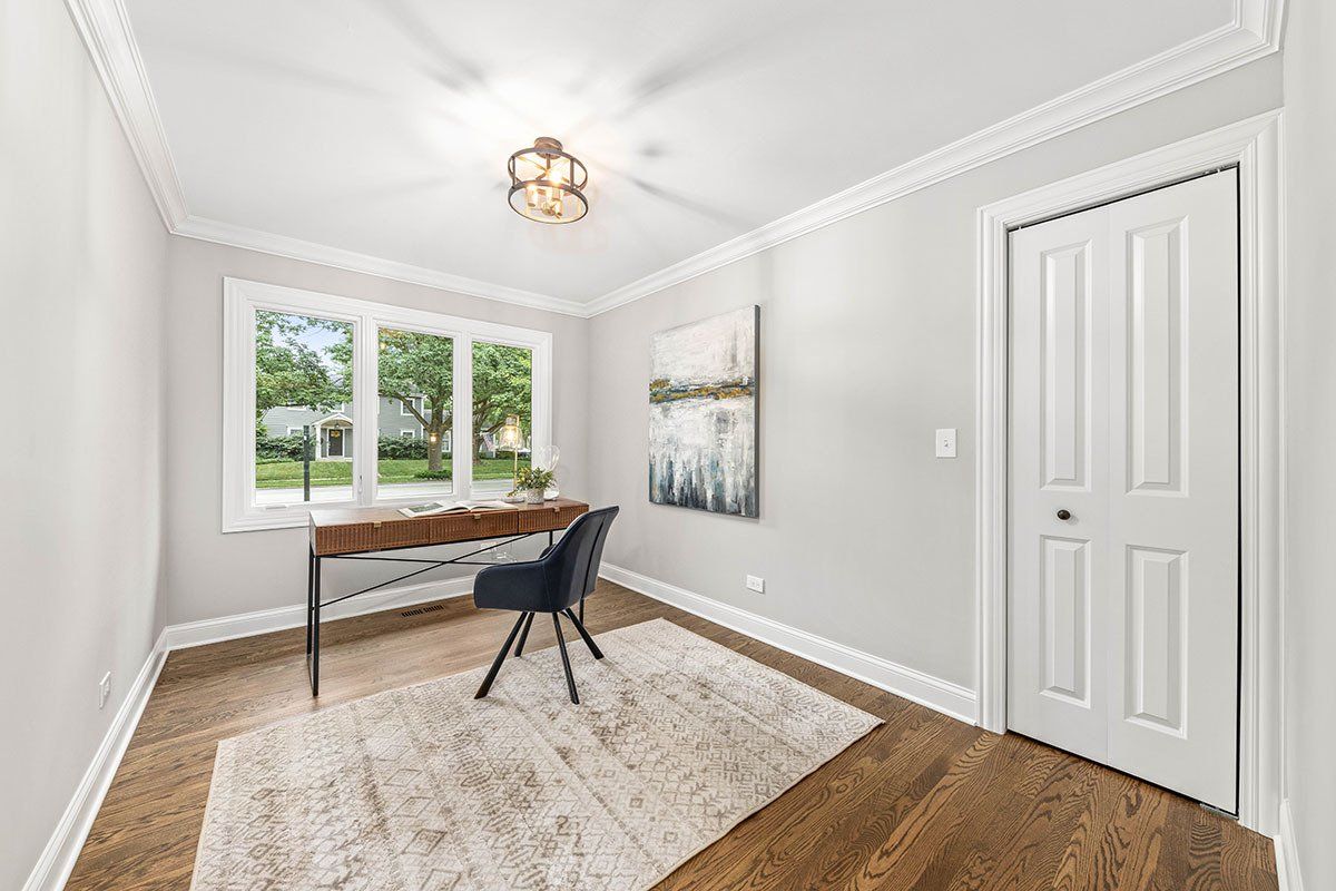 There is a desk and chair in the room.