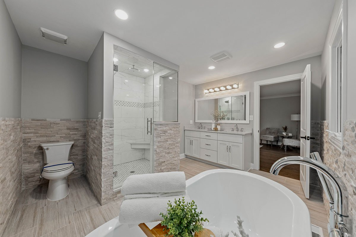 A bathroom with a tub , toilet and shower.