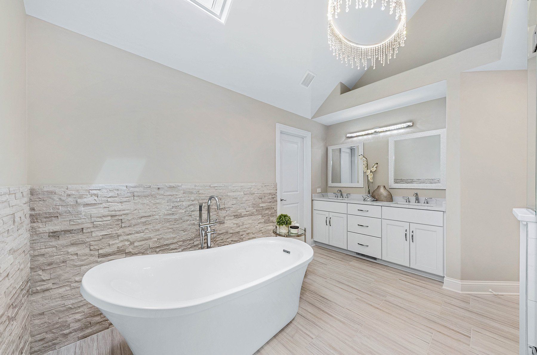 There is a bathtub in the middle of the bathroom.