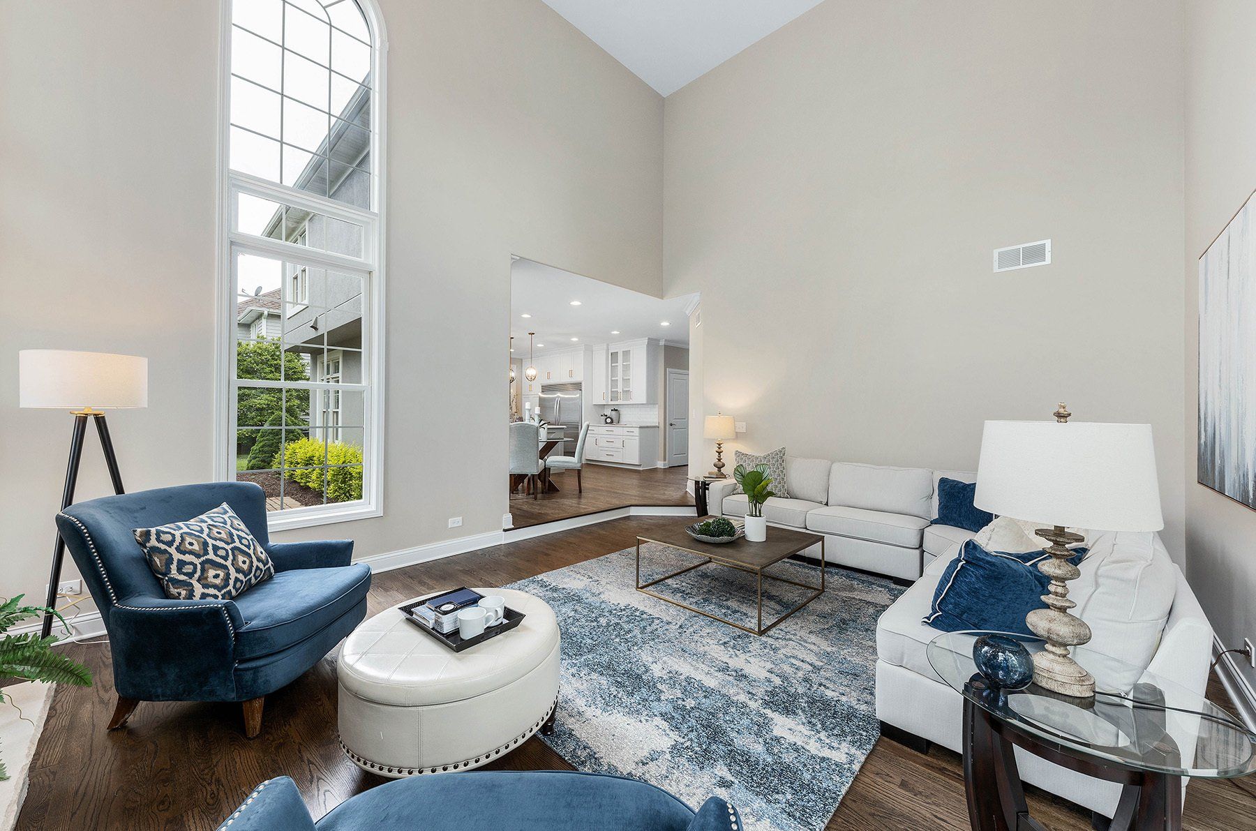A living room filled with furniture and a large window.