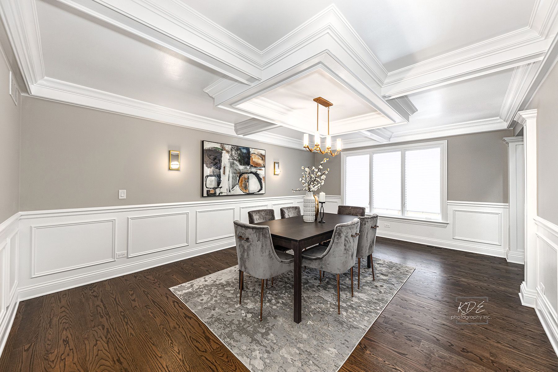 A dining room with a table and chairs and a chandelier.
