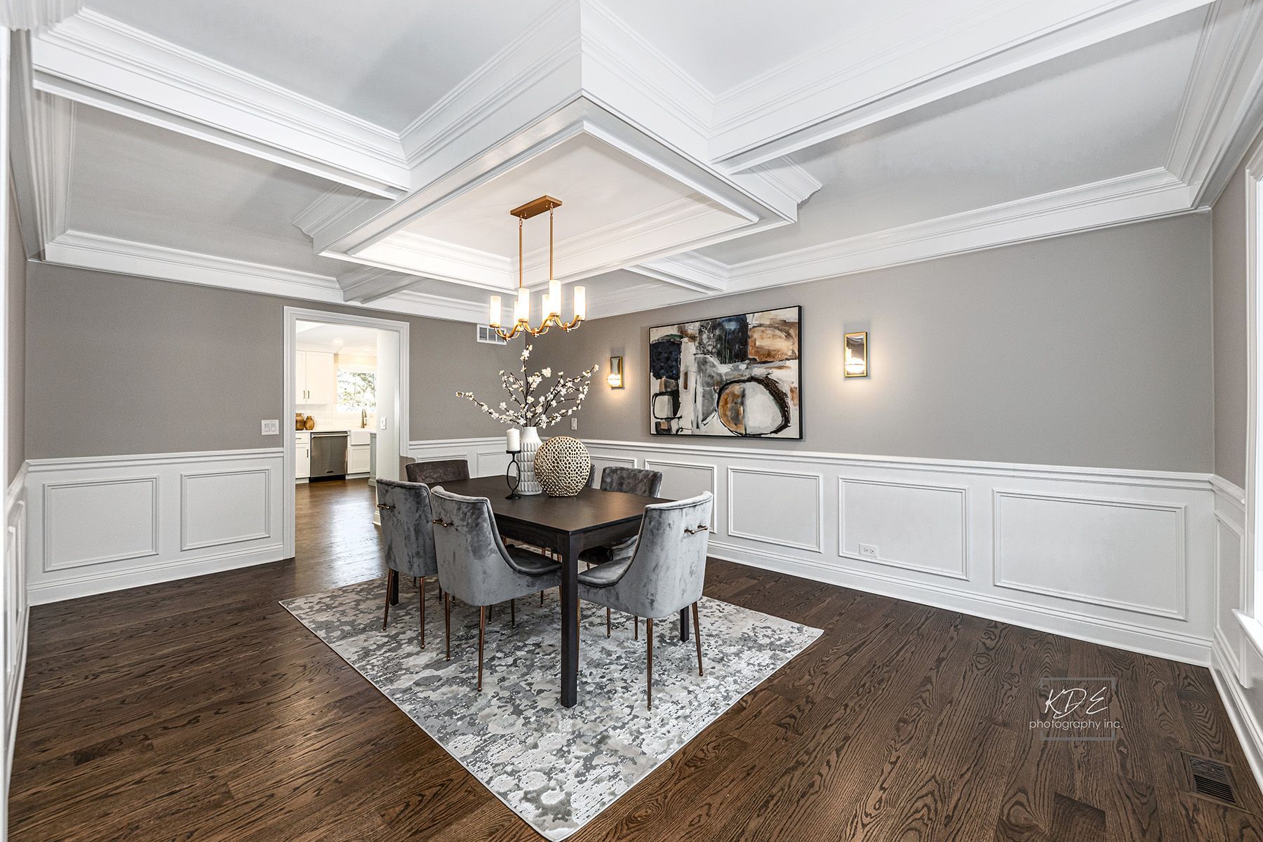 A dining room with a table and chairs and a chandelier.