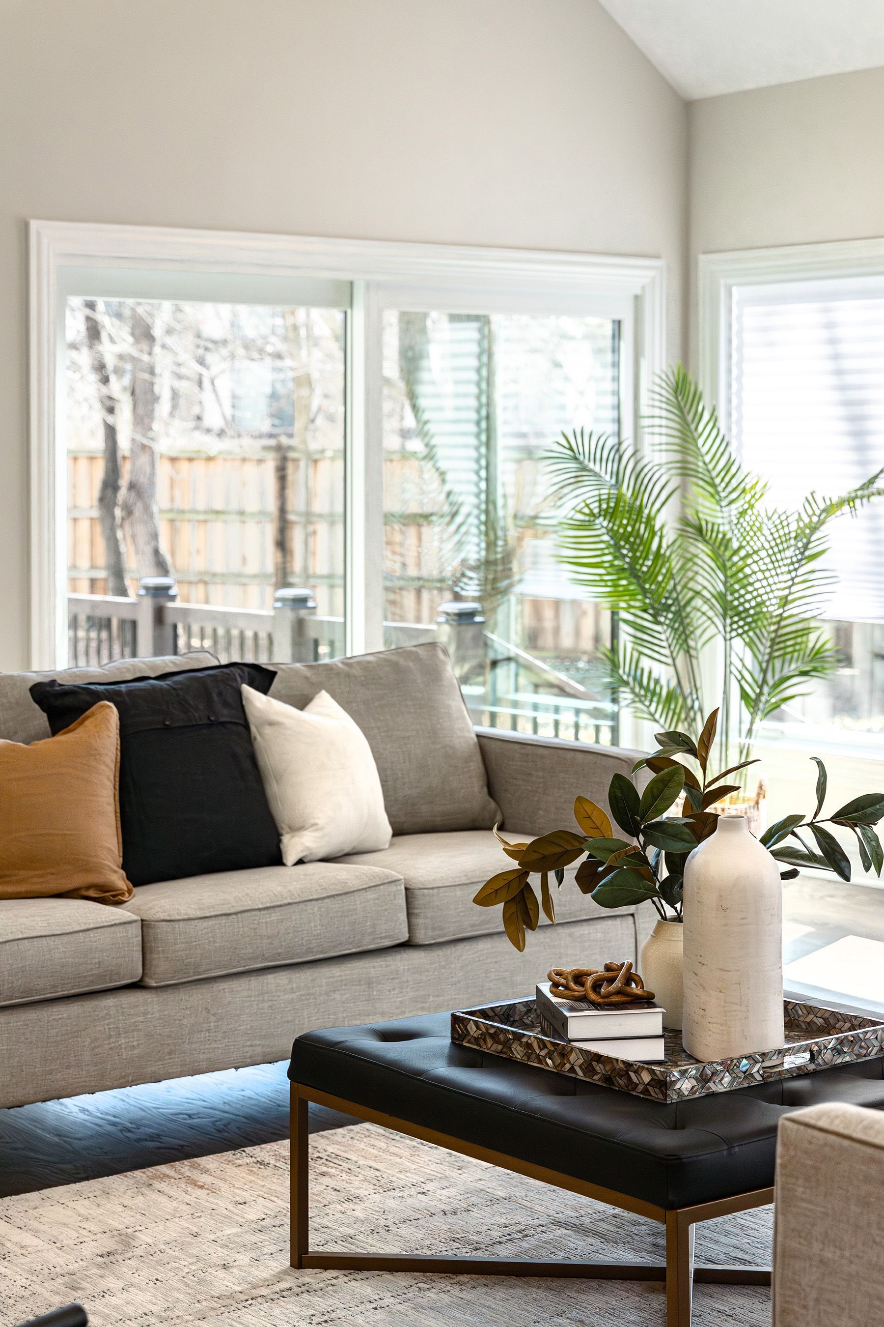 A living room with a couch , coffee table , and window.