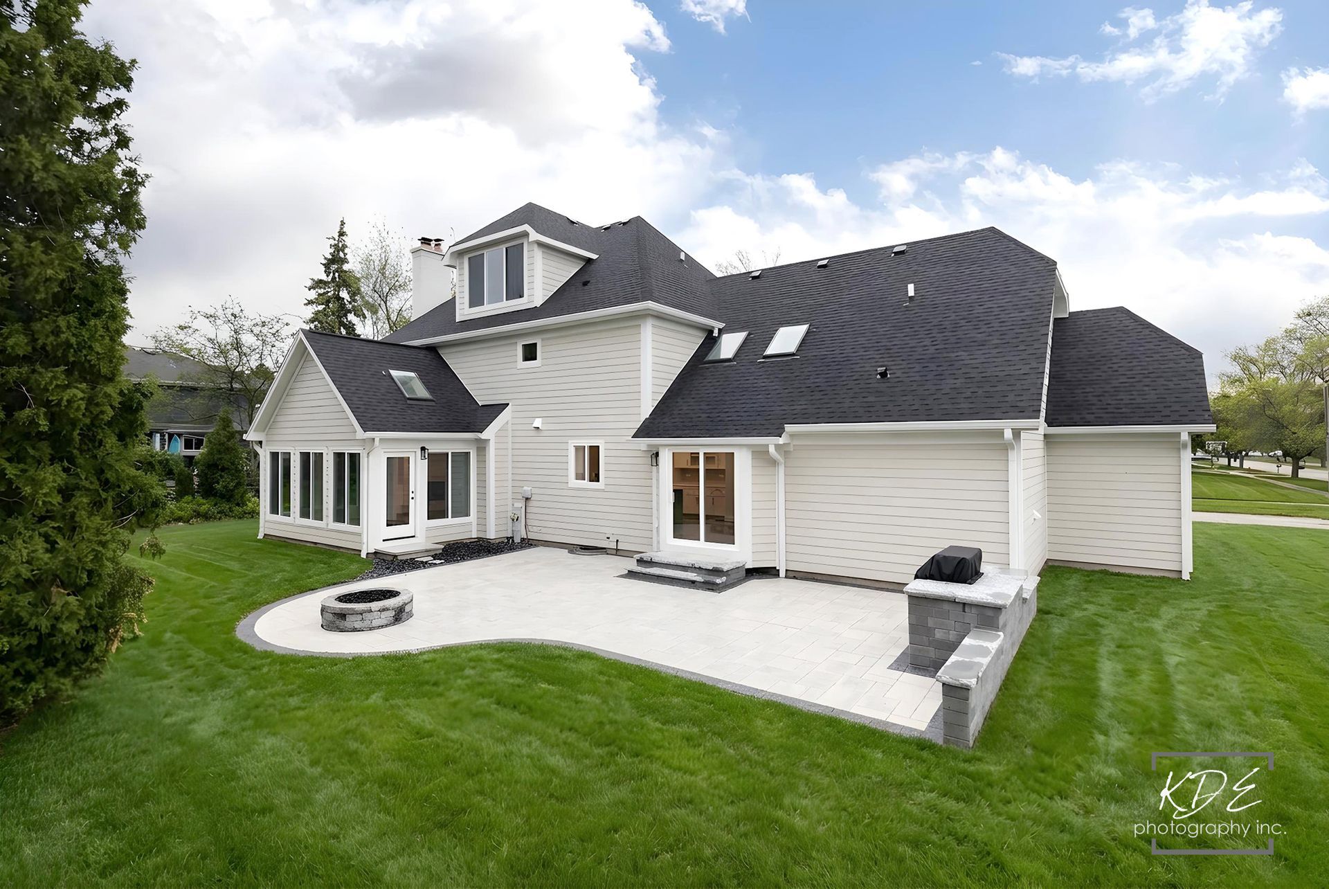 A large house with a lot of windows and a large driveway