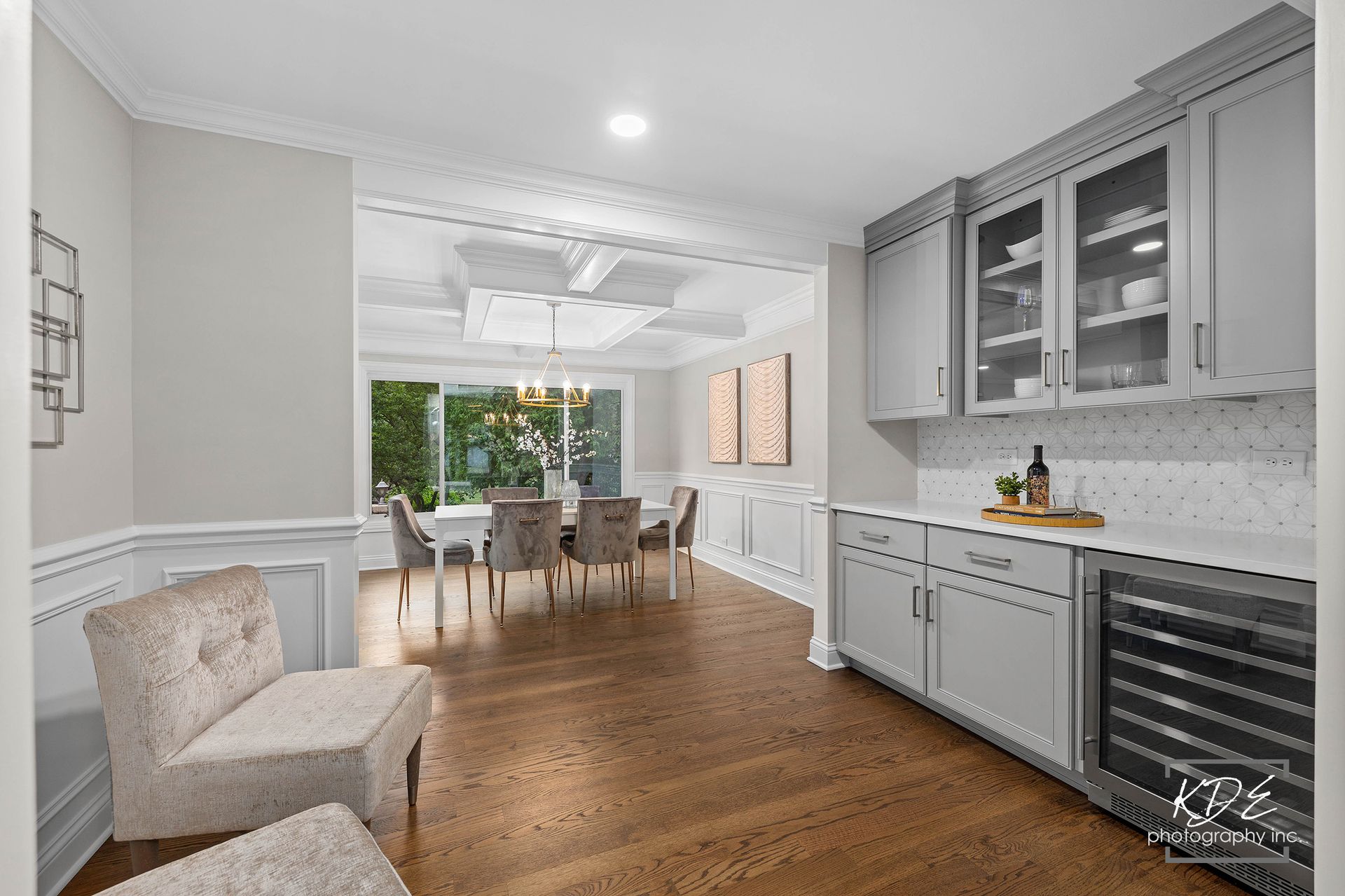 A living room with a dining room in the background
