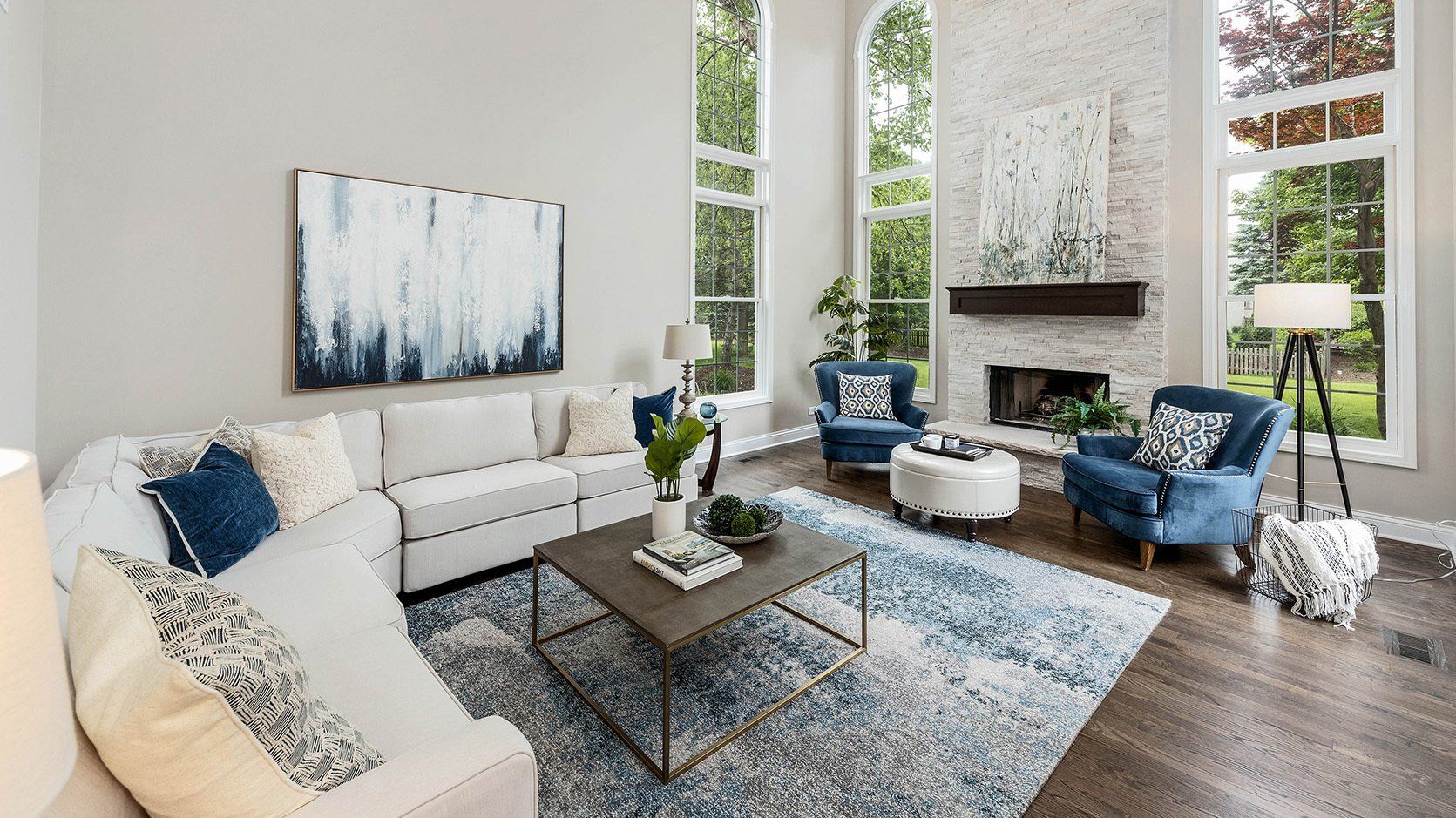 A living room with a couch , chairs , coffee table and fireplace.