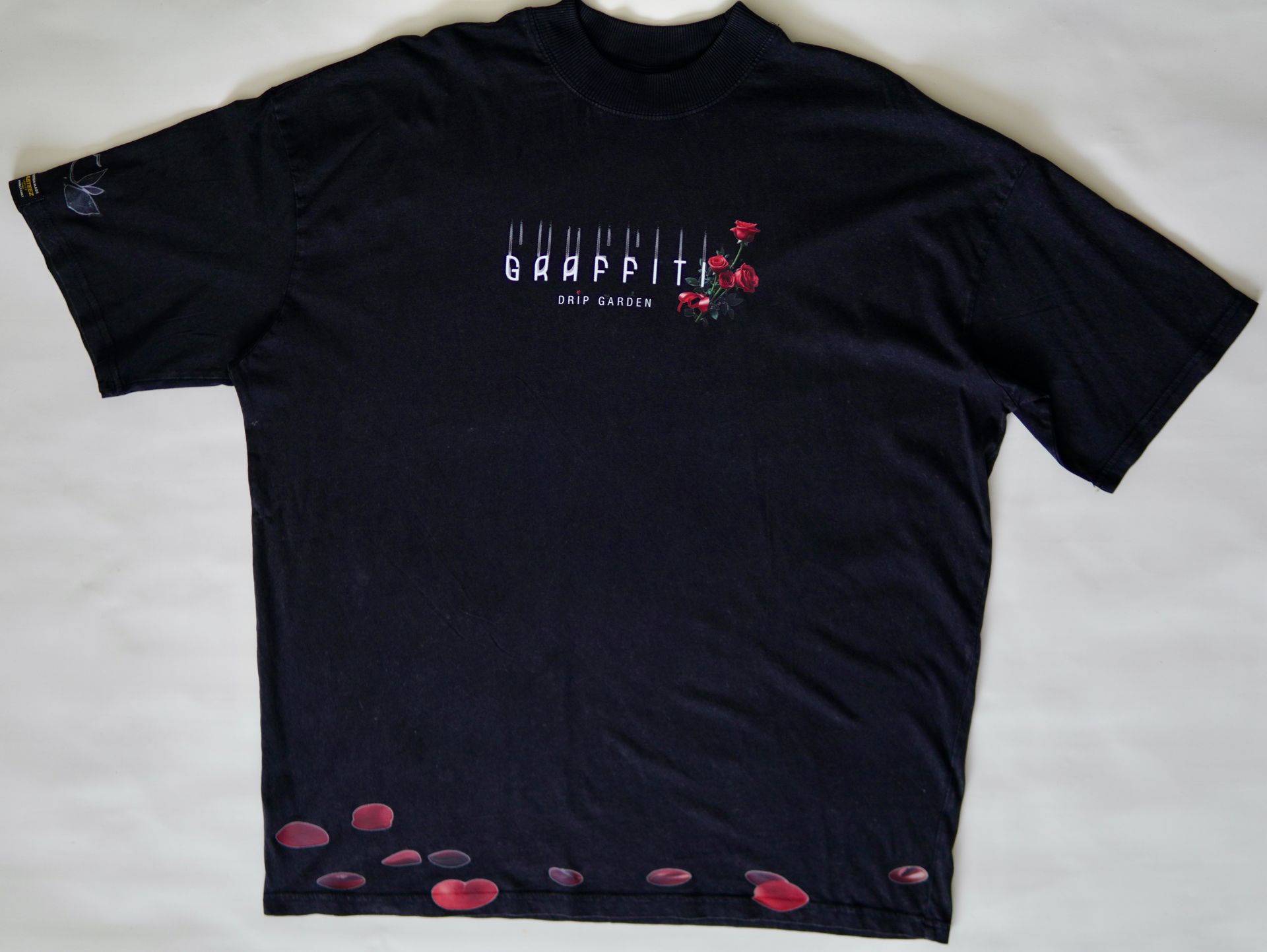 Black t-shirt with white and red graphic. Text says 