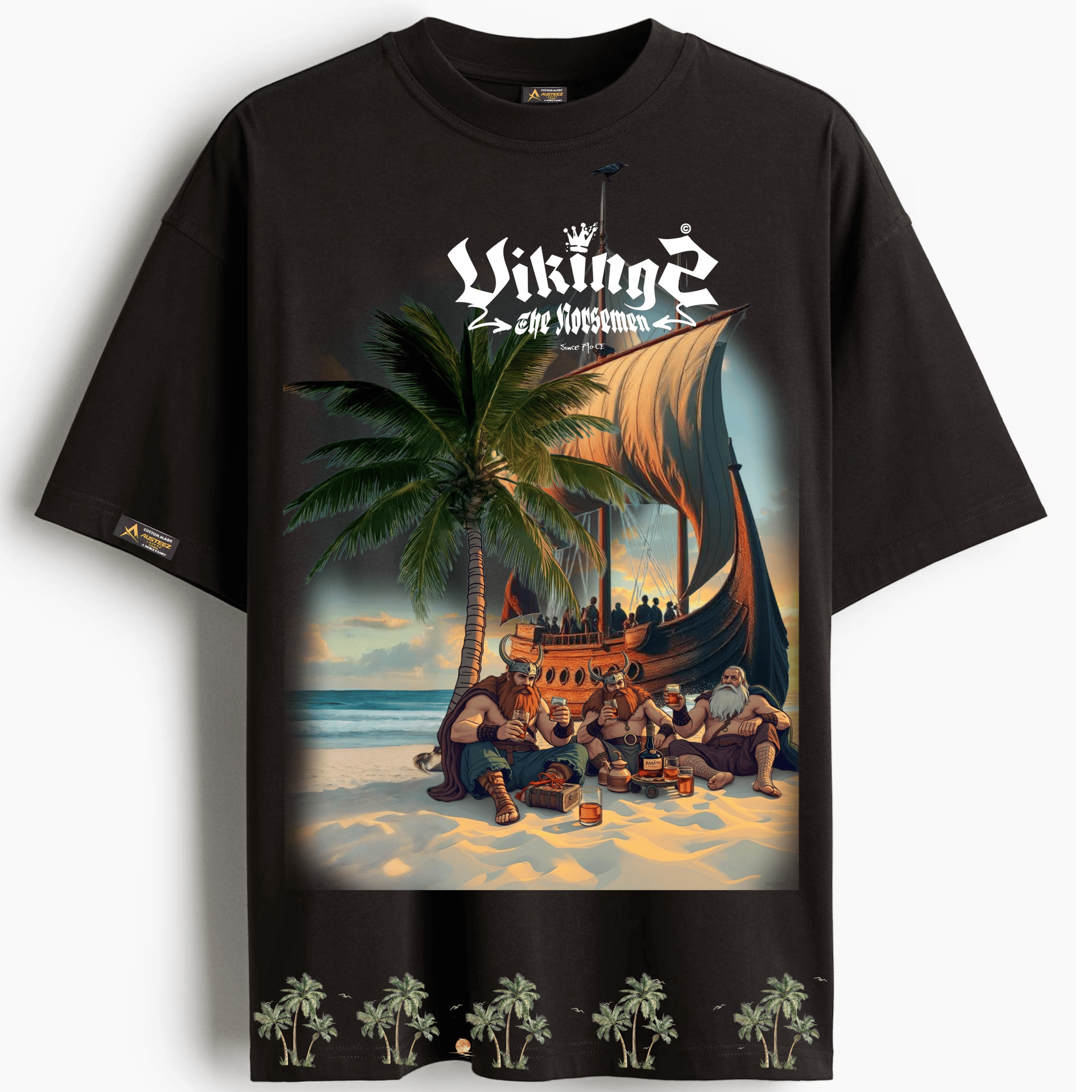 Black t-shirt with Viking scene on a beach, featuring a ship, palm trees, and people.