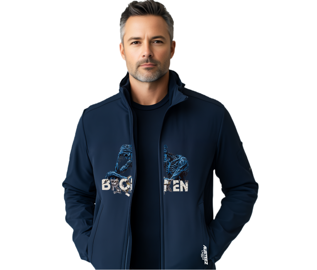 Man wearing a navy blue jacket with a graphic, standing against a white background.