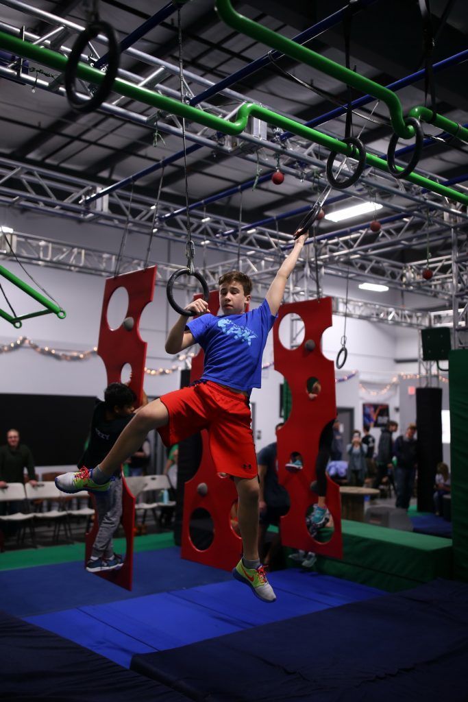 Young athlete training on rings