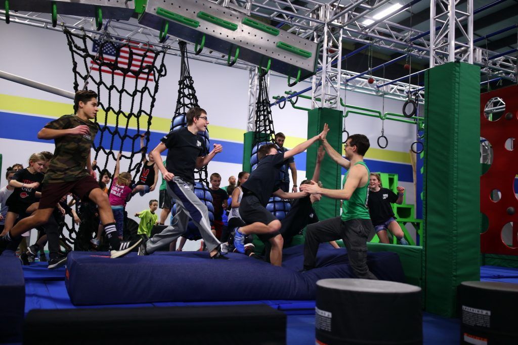 Group of children running through obstacle course