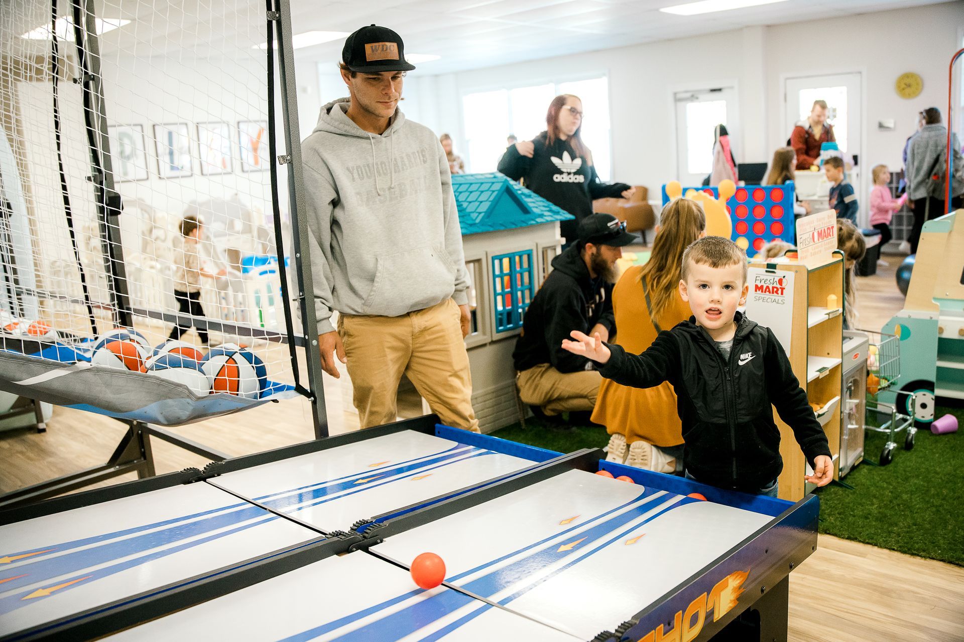 A group of of parents and children are playing at The Lemon Lounge Indoor Playground.