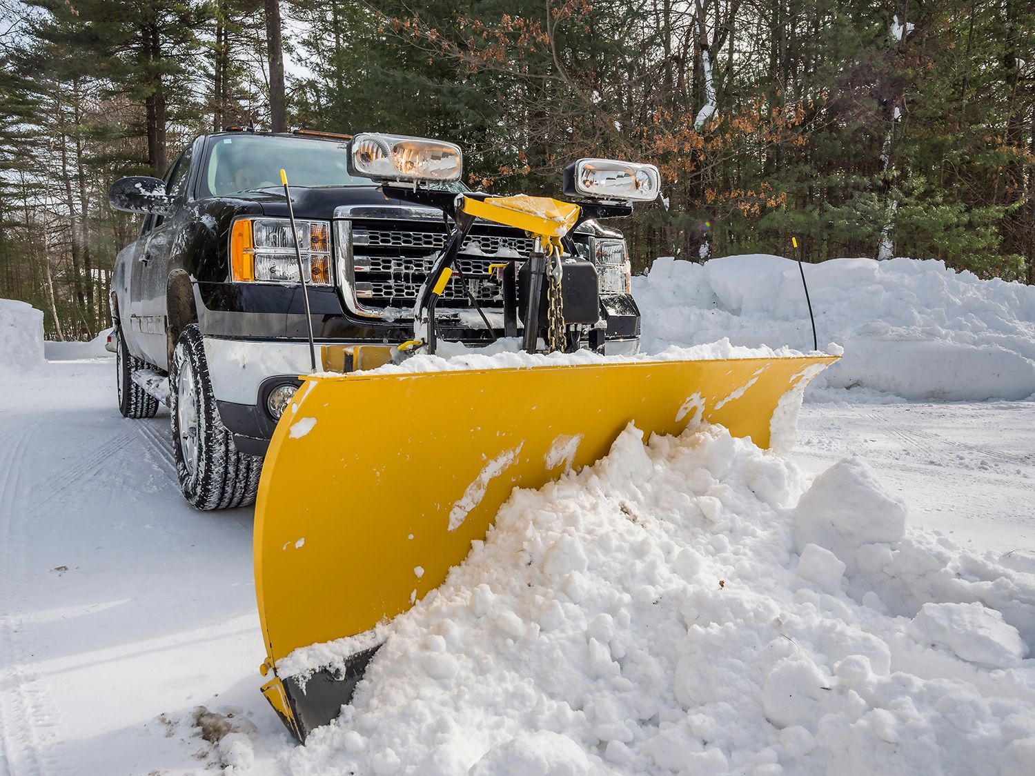 Pickup truck plowing snow off driveway. Pickup truck plowing snow off driveway.