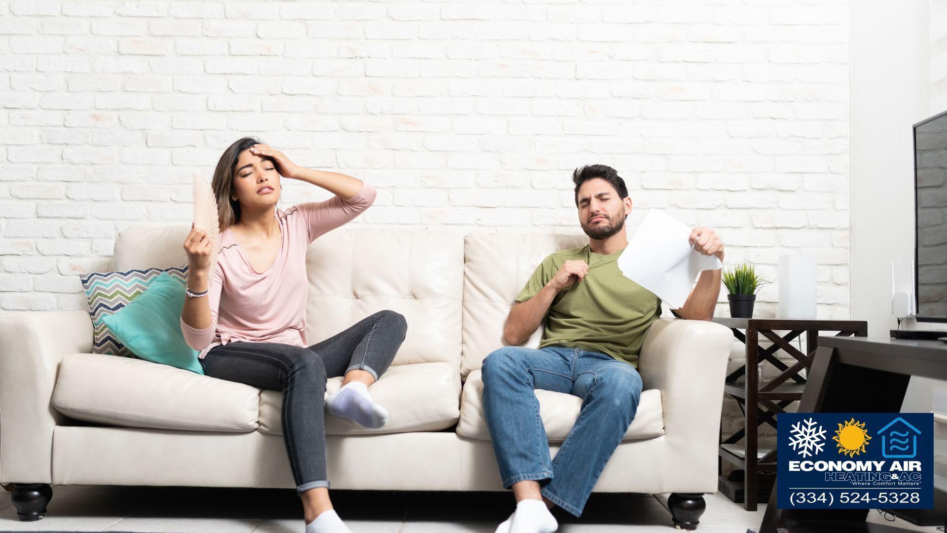 A man and a woman are sitting on a couch in a living room.