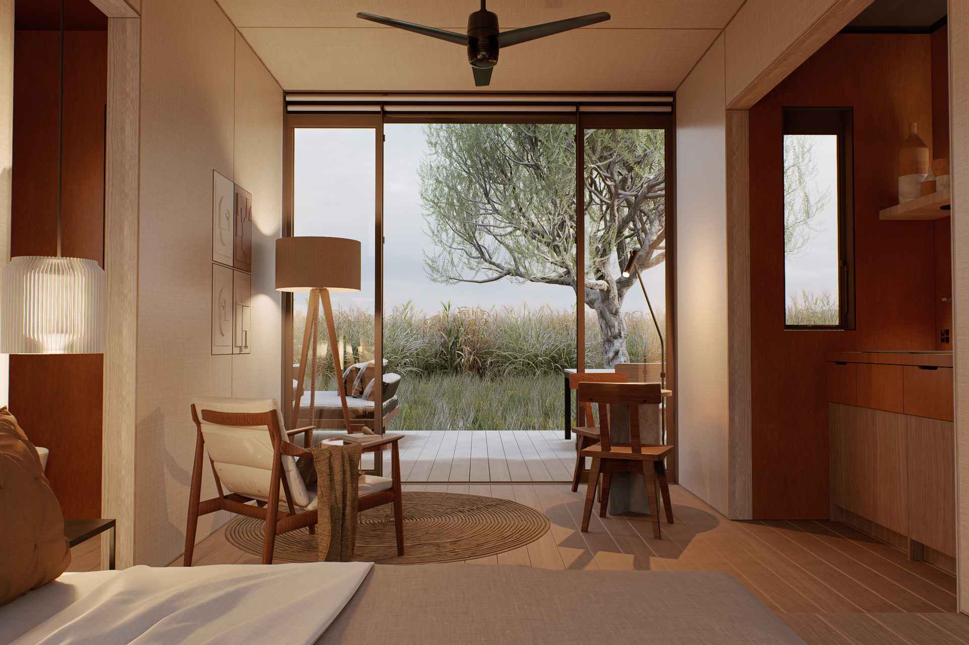 Cozy interior with a bed, chairs, table, and large window overlooking a natural landscape.