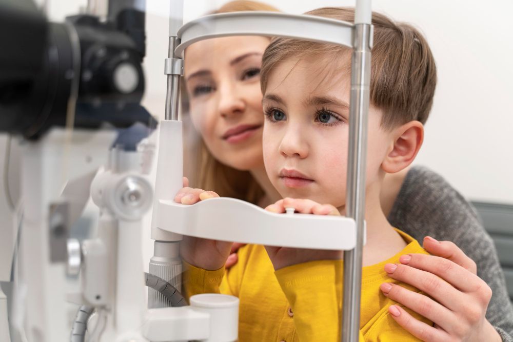 A little boy is getting his eyes examined by an ophthalmologist.