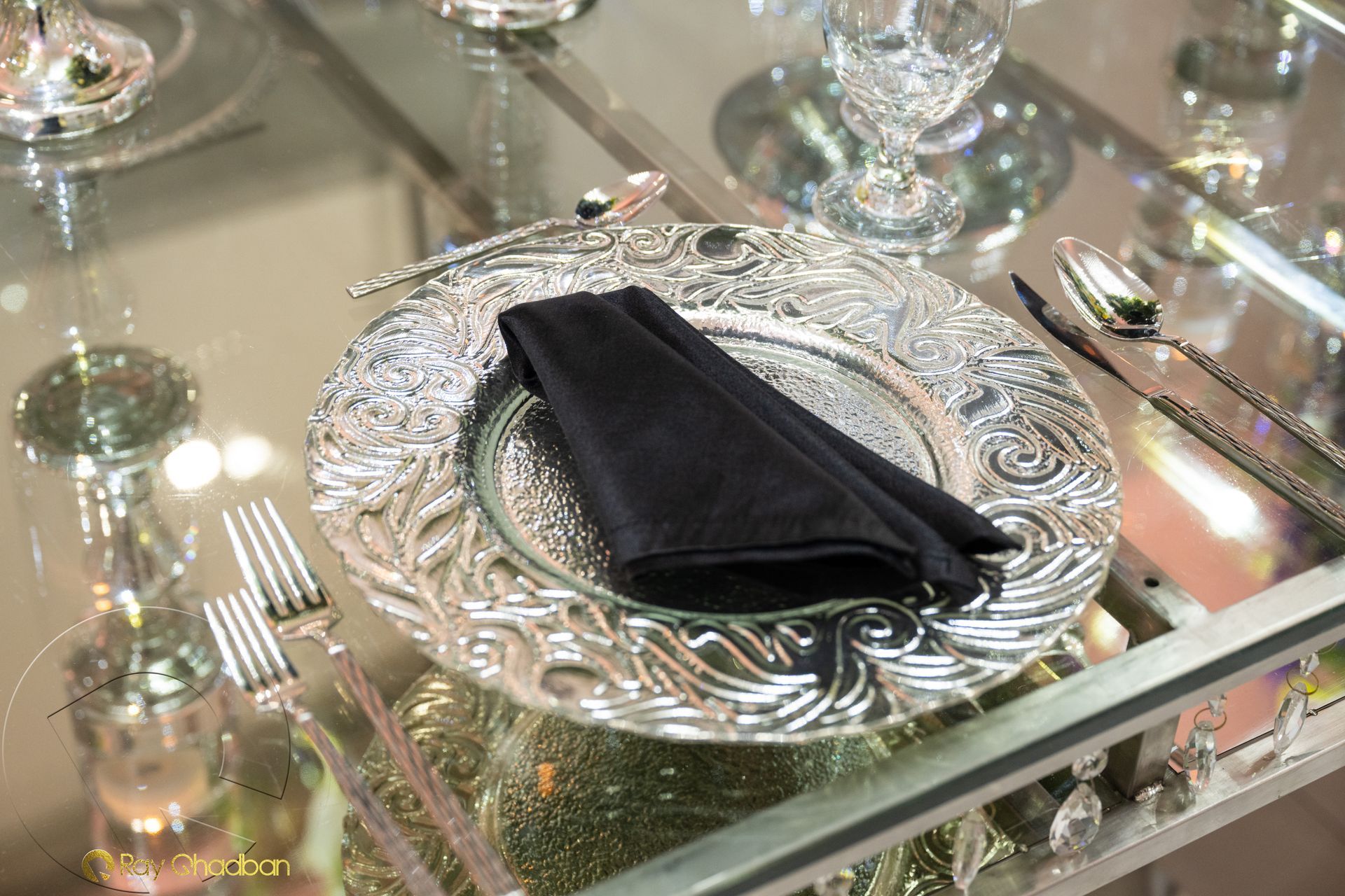 table wth black napkin and silver plate