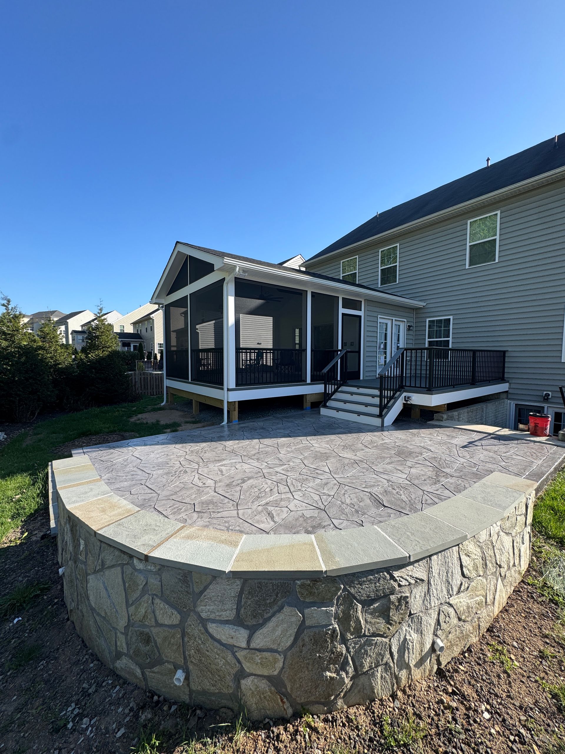 Trex screened in porch with Screen-Eze and Westbury Aluminum handrails, and Stamped Concrete in Aldie, VA