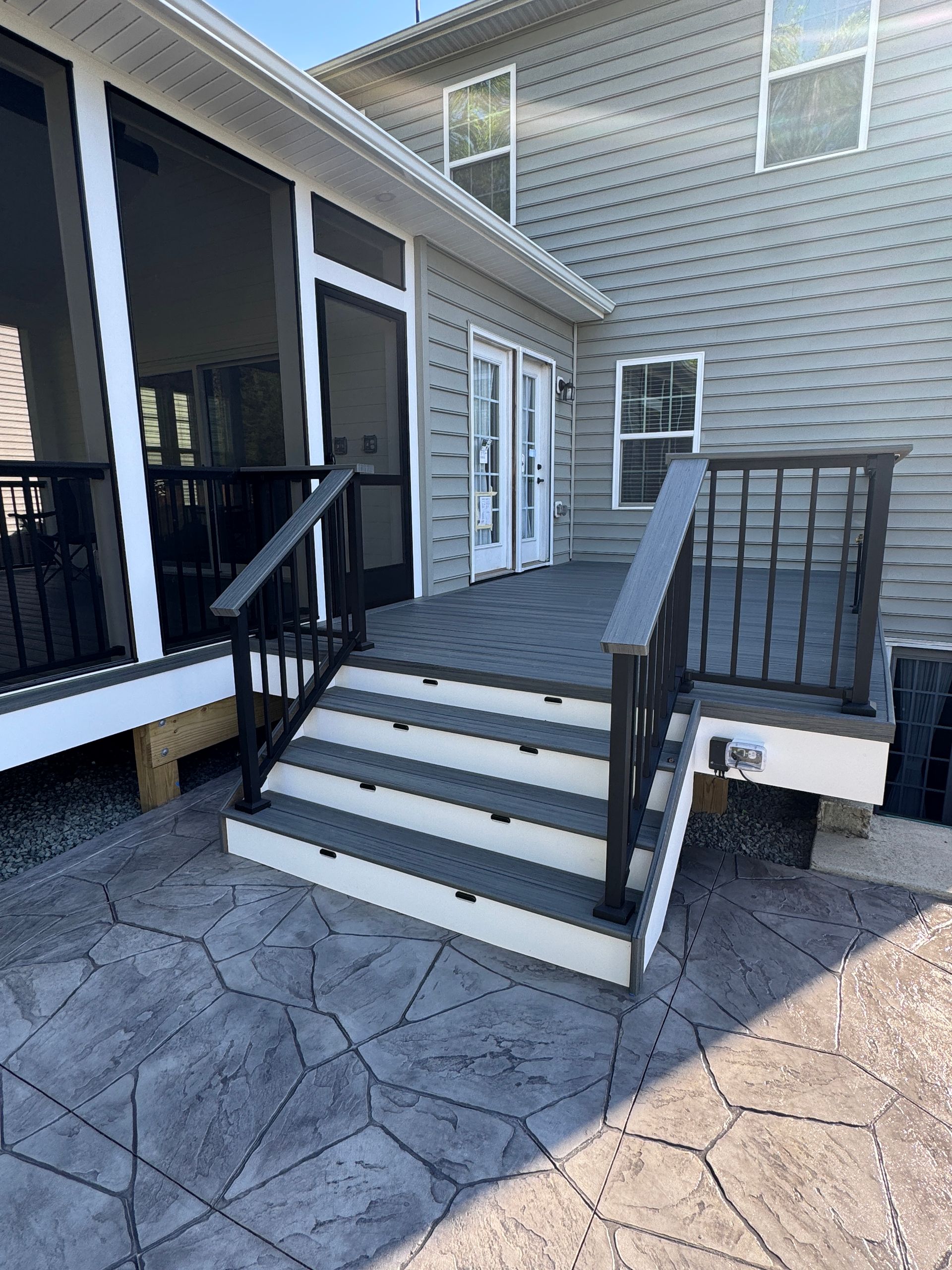 Trex screened in porch with Screen-Eze and Westbury Aluminum handrails, and Stamped Concrete in Aldie, VA