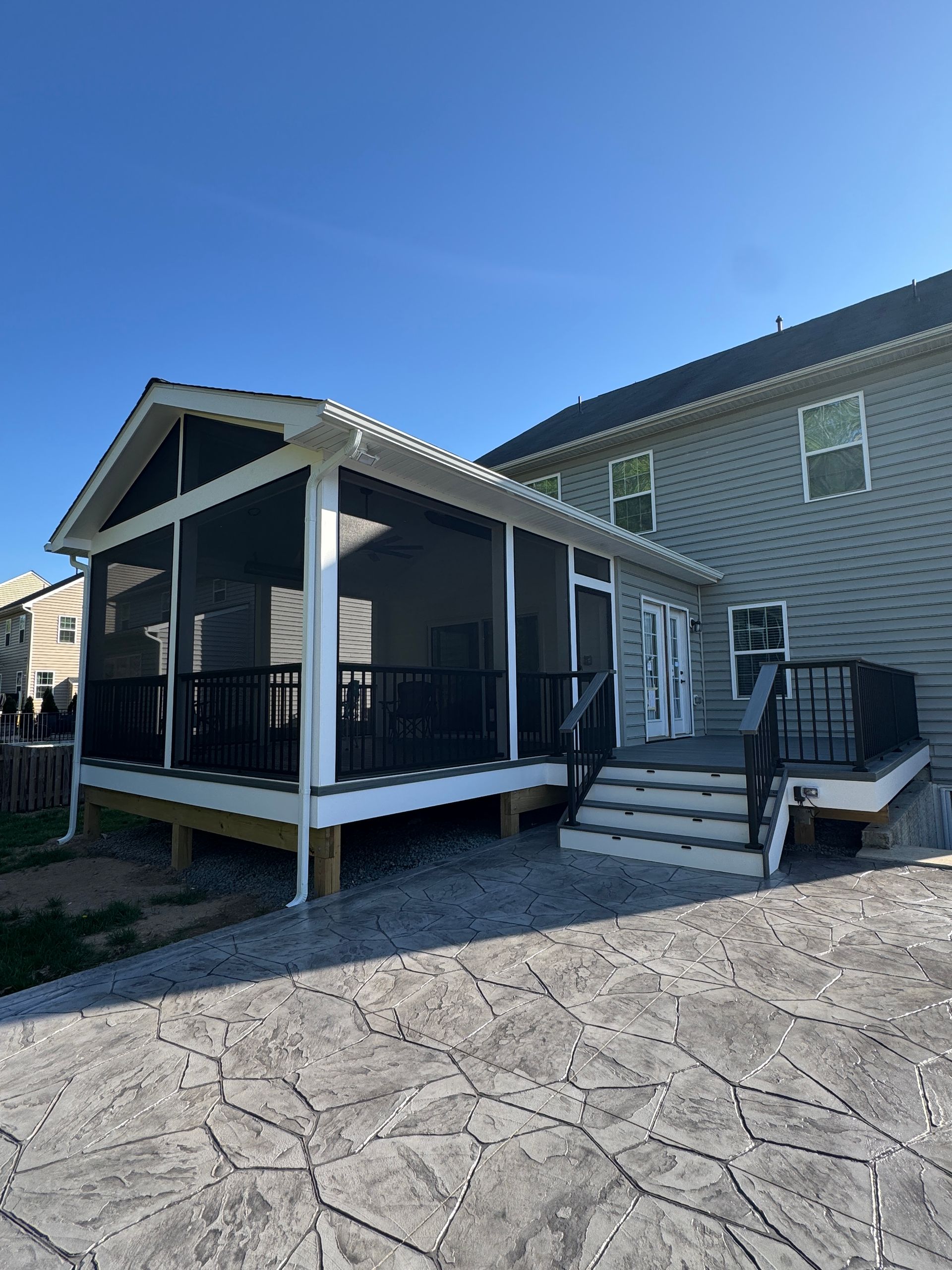 Trex screened in porch with Screen-Eze and Westbury Aluminum handrails, and Stamped Concrete in Aldie, VA