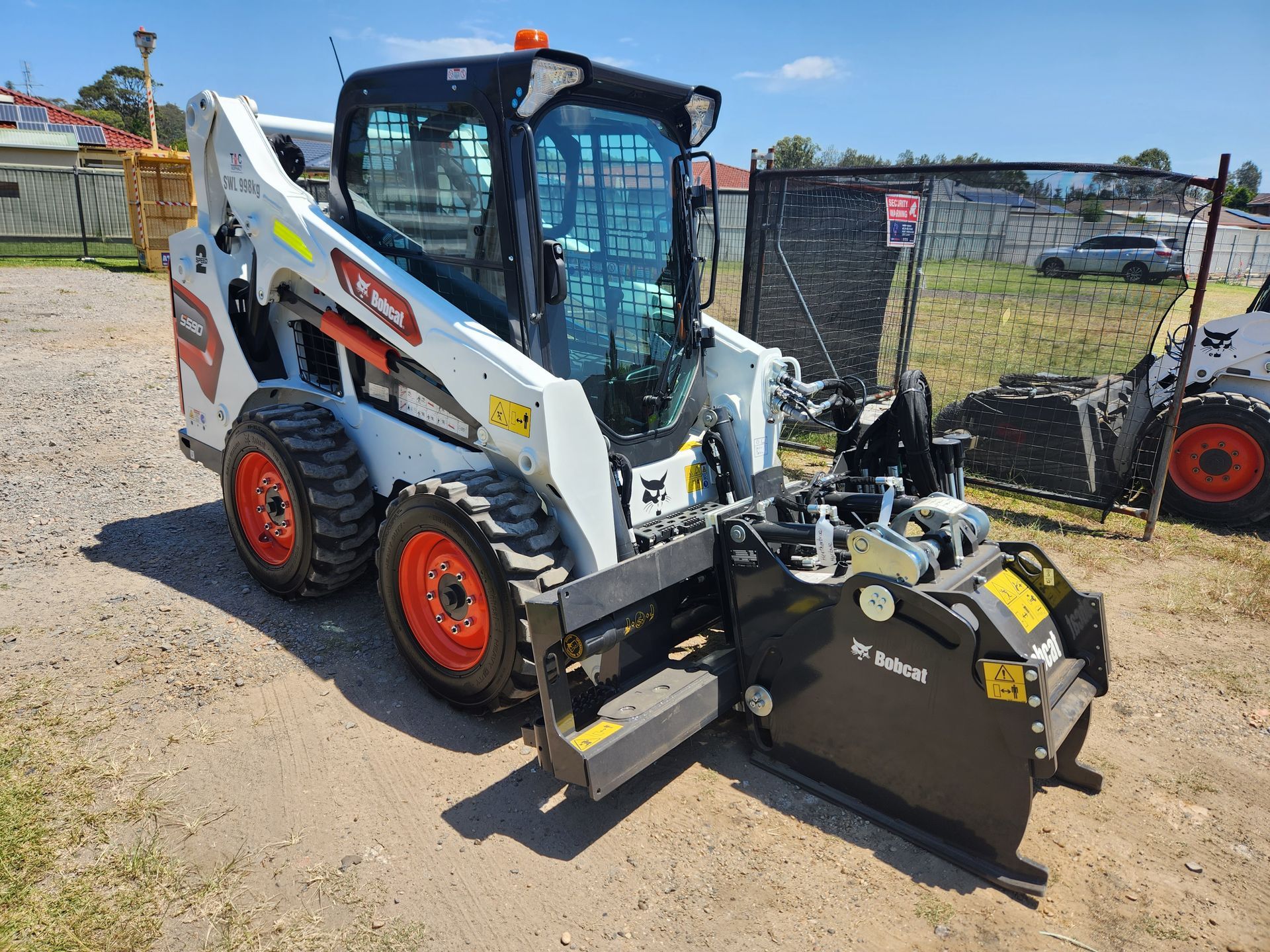 White Bobcat Skid-steer Loader With Brush Cutter Attachment — TAC Asphalt Services in Warners Bay, NSW