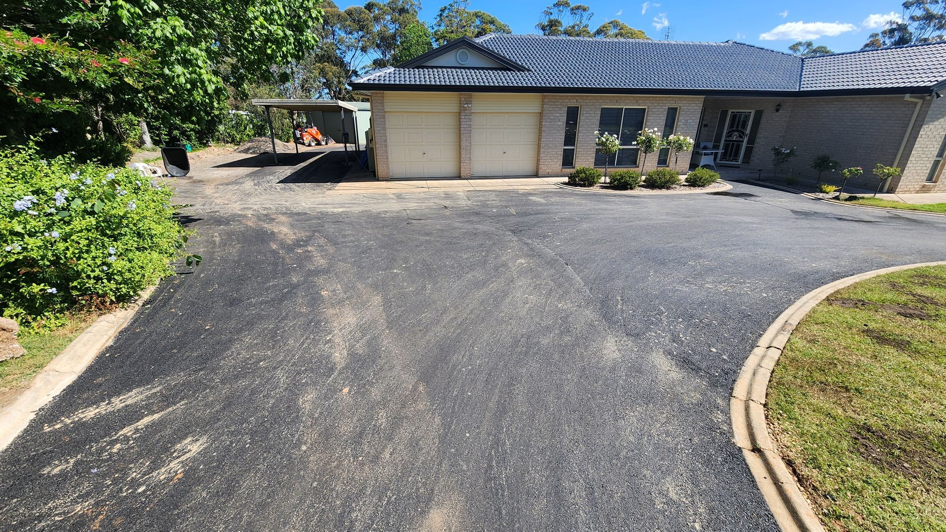 Asphalt Driveway Leading To A Suburban House — TAC Asphalt Services in Warners Bay, NSW