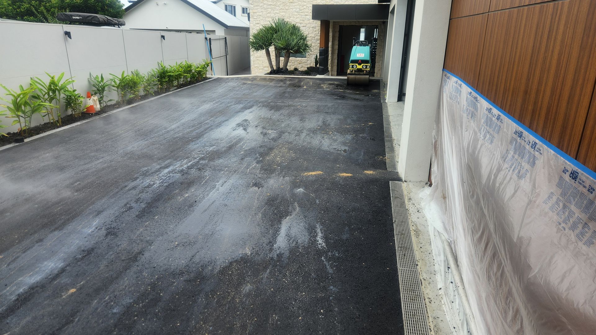 Asphalt Driveway With White Splotches — TAC Asphalt Services in Warners Bay, NSW