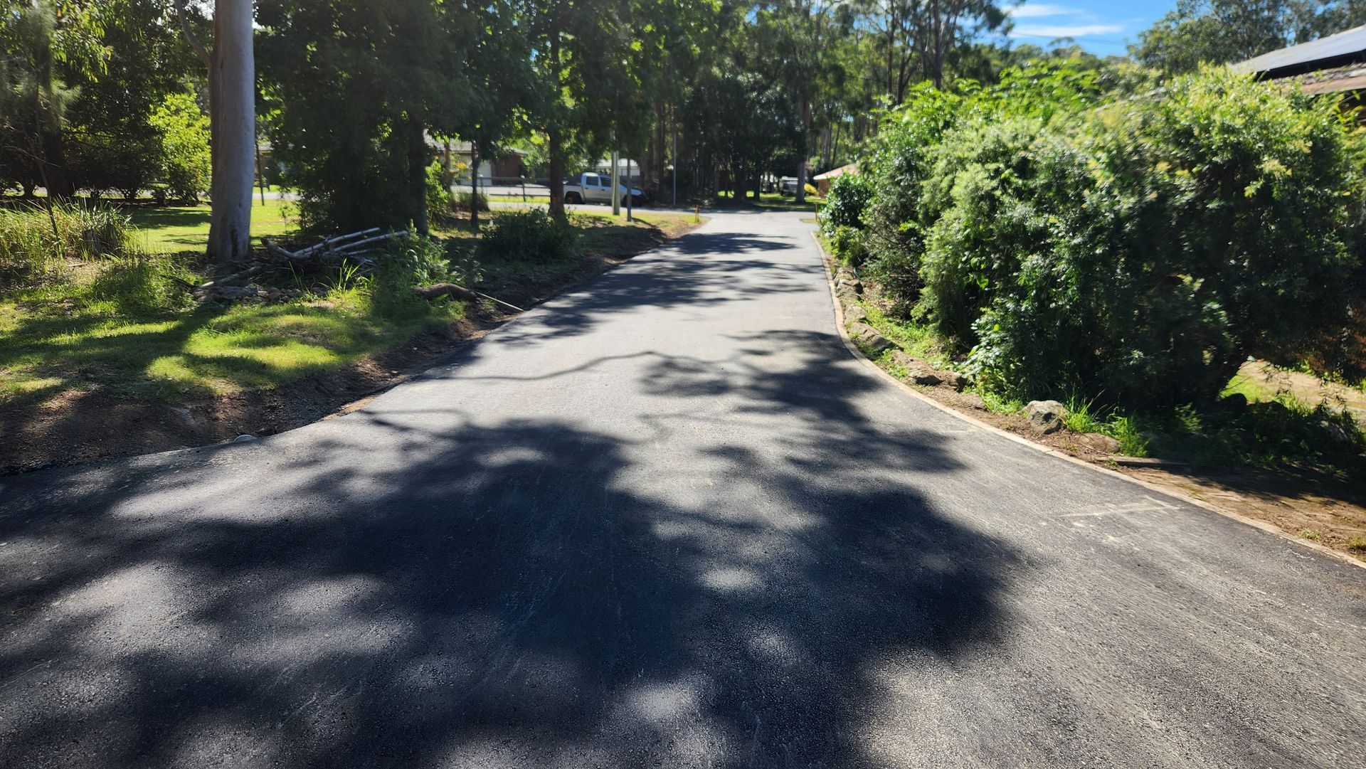 Asphalt Road With Tree Shadows — TAC Asphalt Services in Warners Bay, NSW