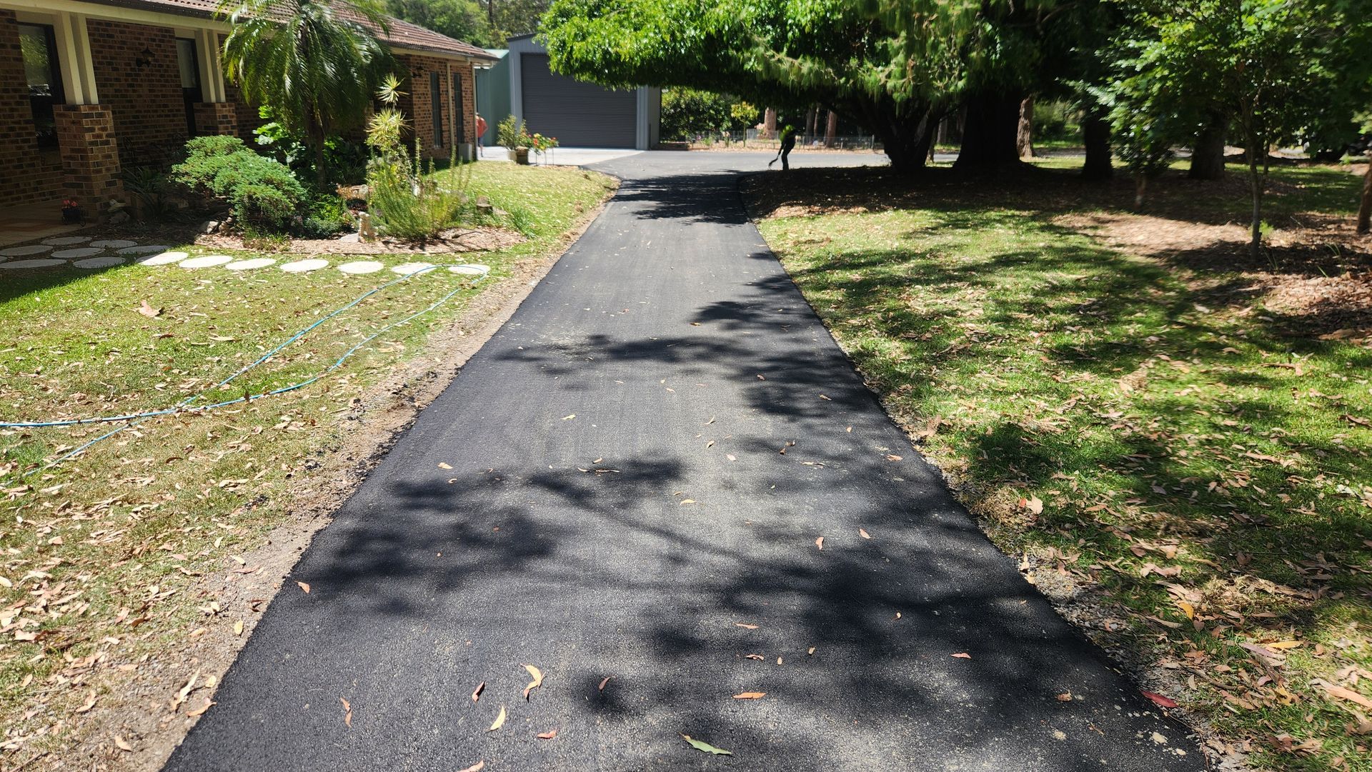 Asphalt Driveway Leading Towards A House — TAC Asphalt Services in Warners Bay, NSW