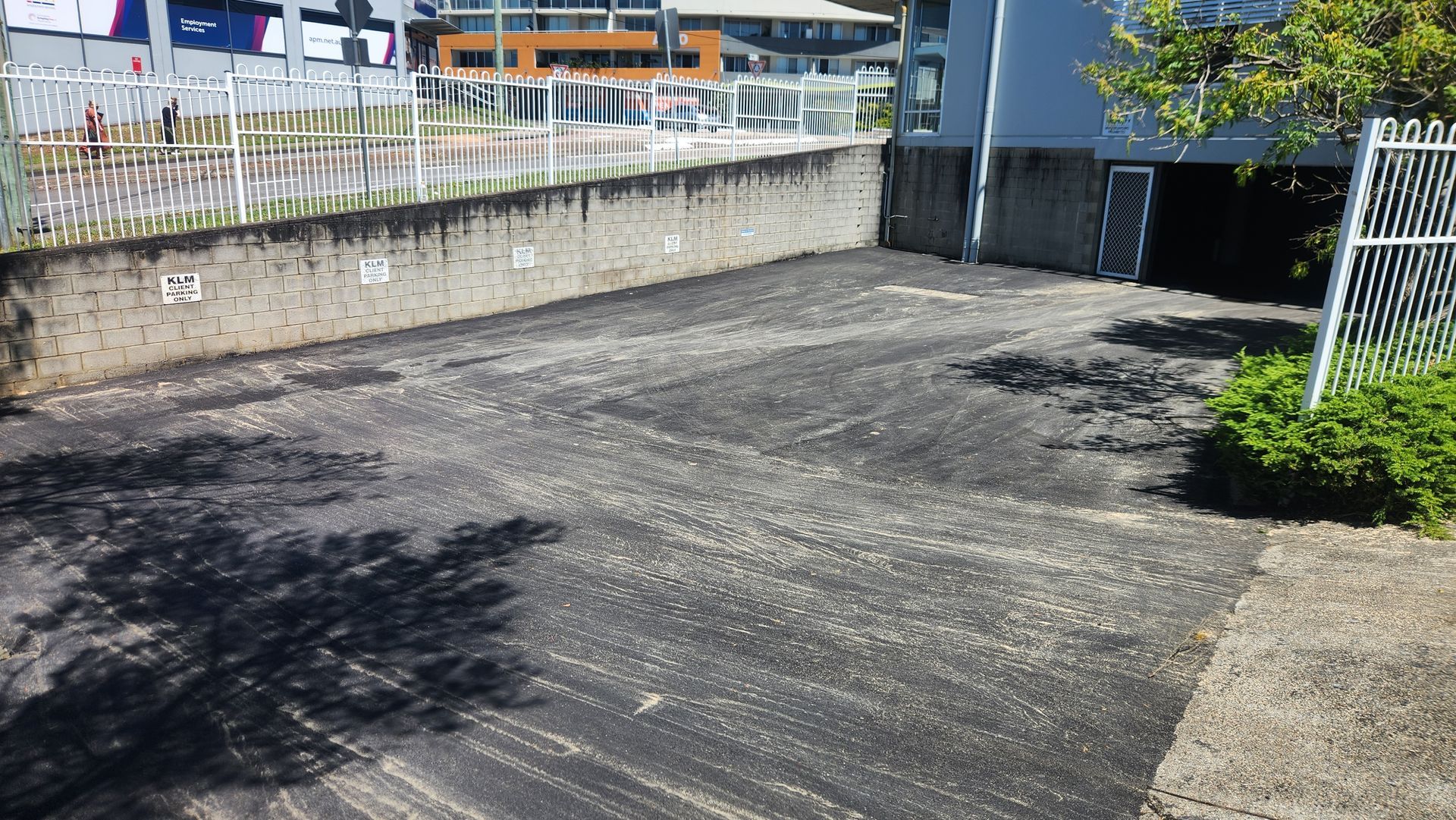 An Empty Parking Area With Asphalt — TAC Asphalt Services in Warners Bay, NSW