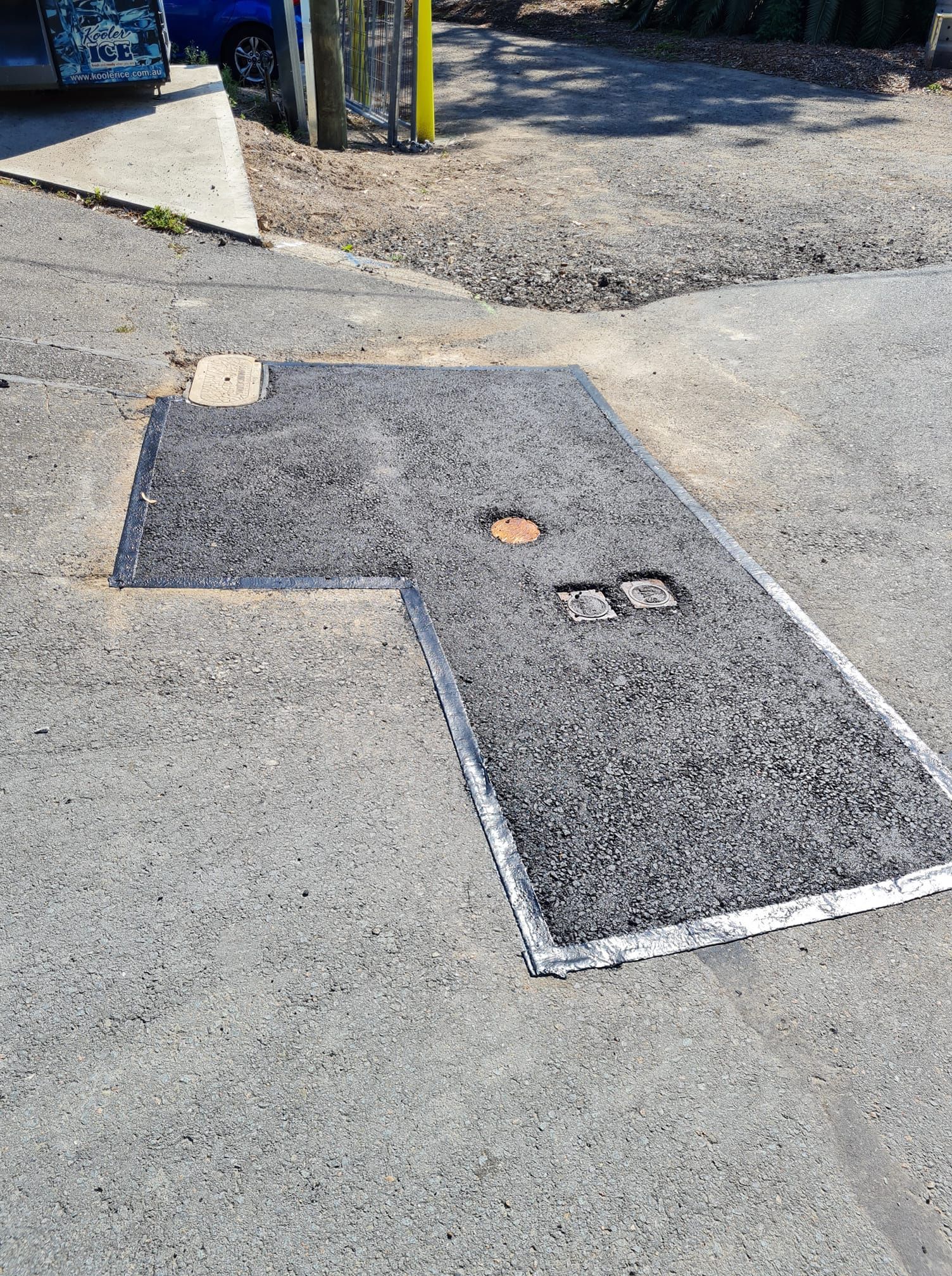 Asphalt Patch With Metal Frame in a Road — TAC Asphalt Services in Warners Bay, NSW