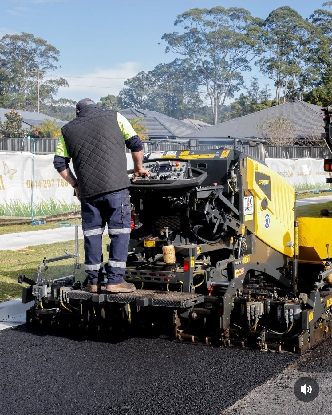 Person Operating Asphalt Paving Machine On A Road — TAC Asphalt Services in Warners Bay, NSW