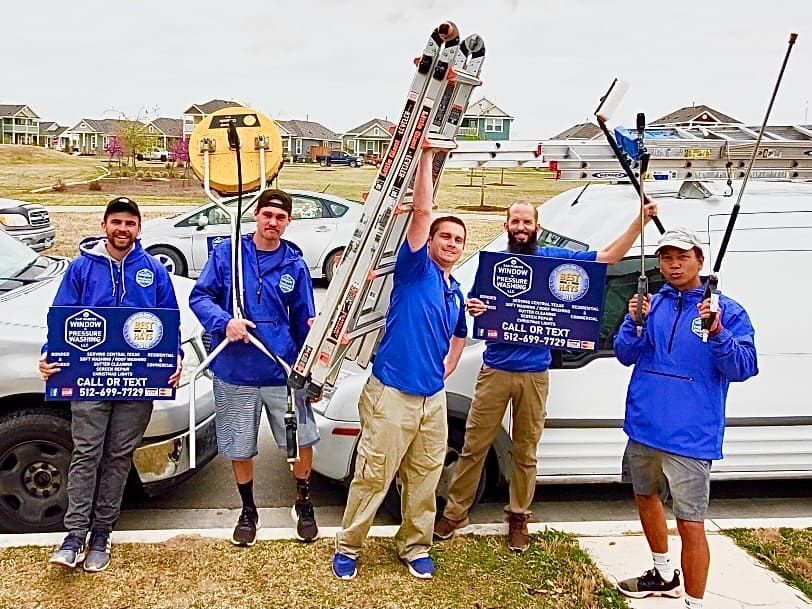 A group of men are standing in front of a truck holding signs.