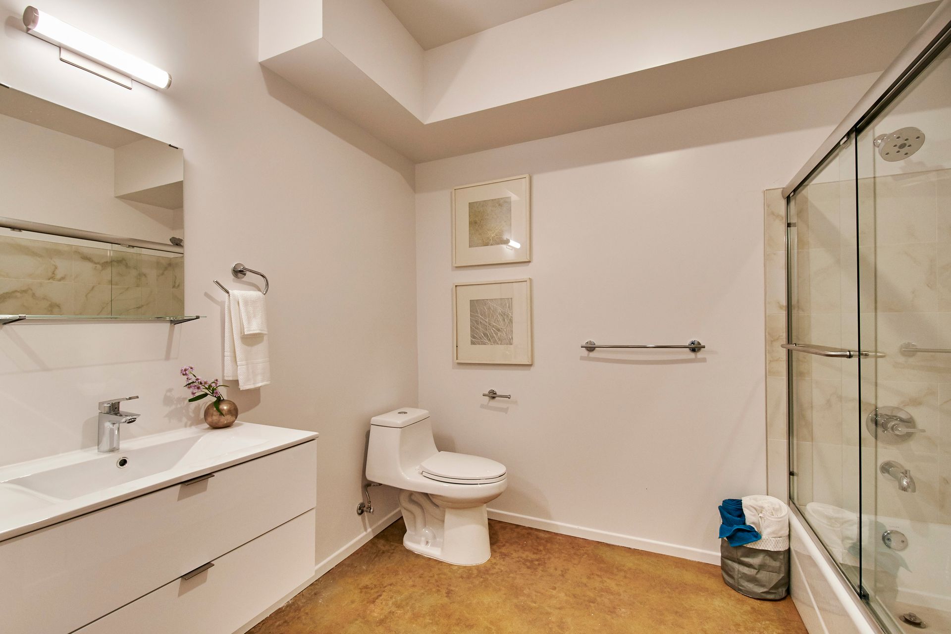 A bathroom with a toilet , sink , and shower.