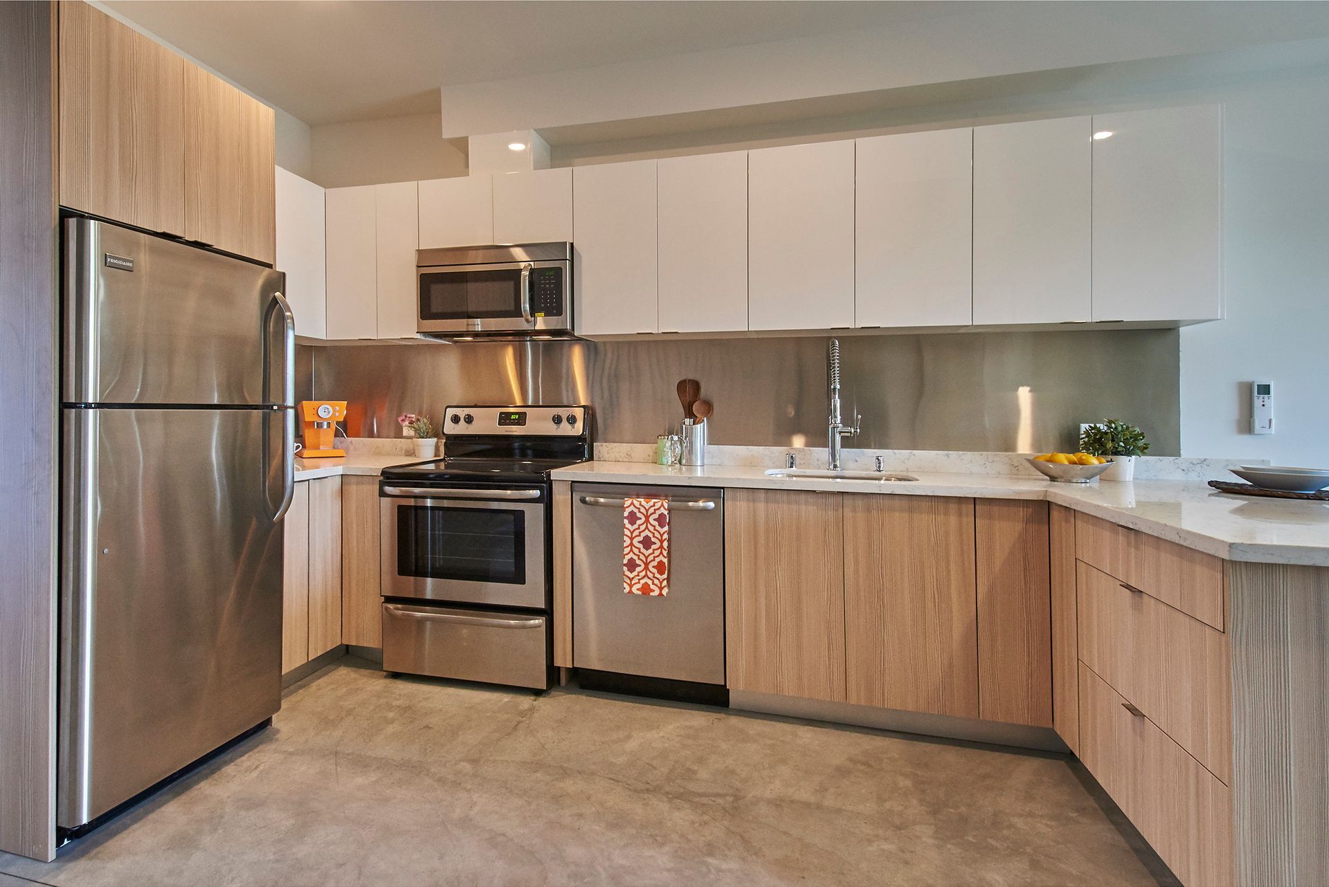 A kitchen with stainless steel appliances and wooden cabinets