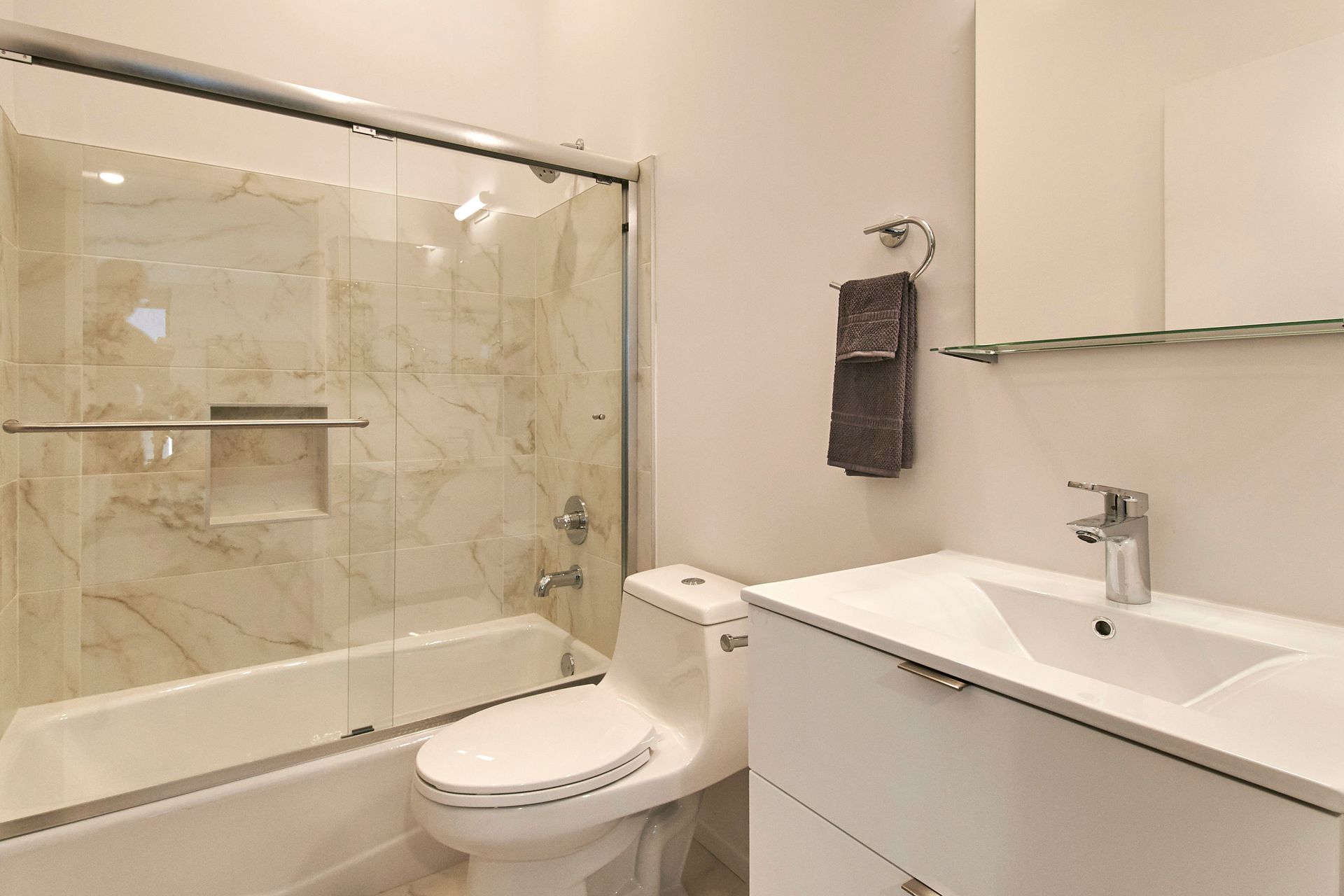 A bathroom with a toilet , sink , tub and shower.